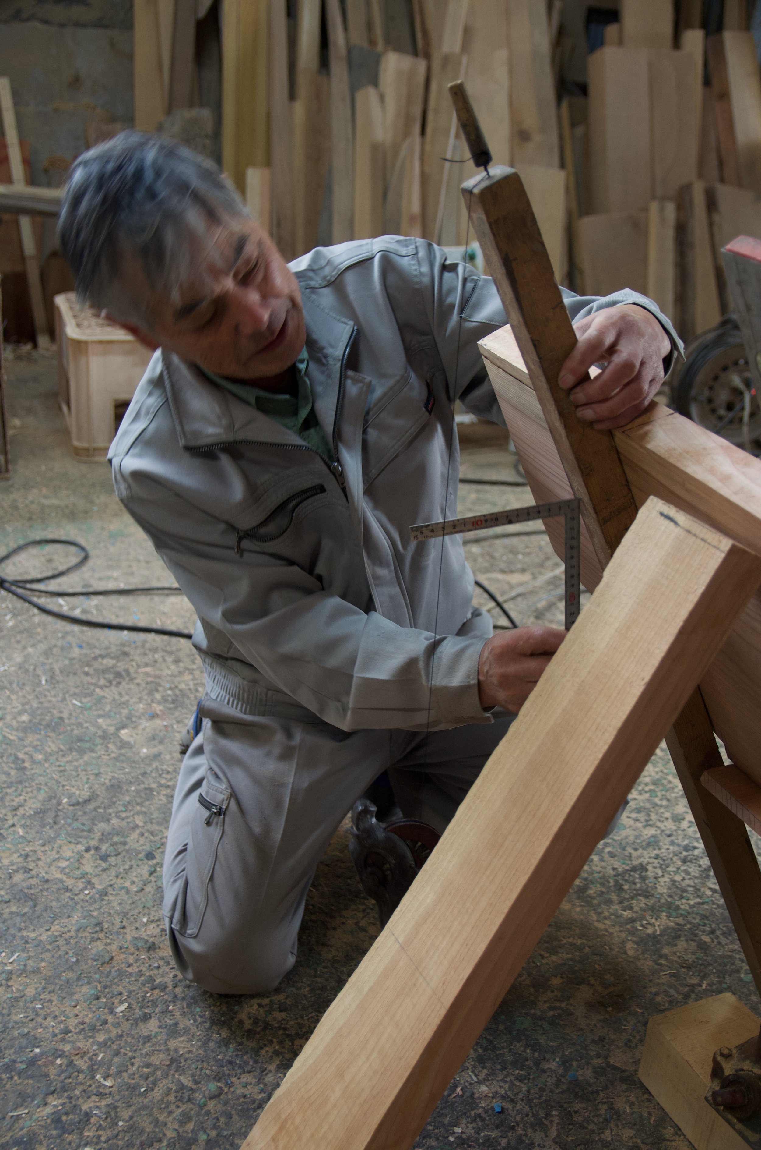 Bansho san sets the angle of the transom measuring from a known mark to a plumb line.