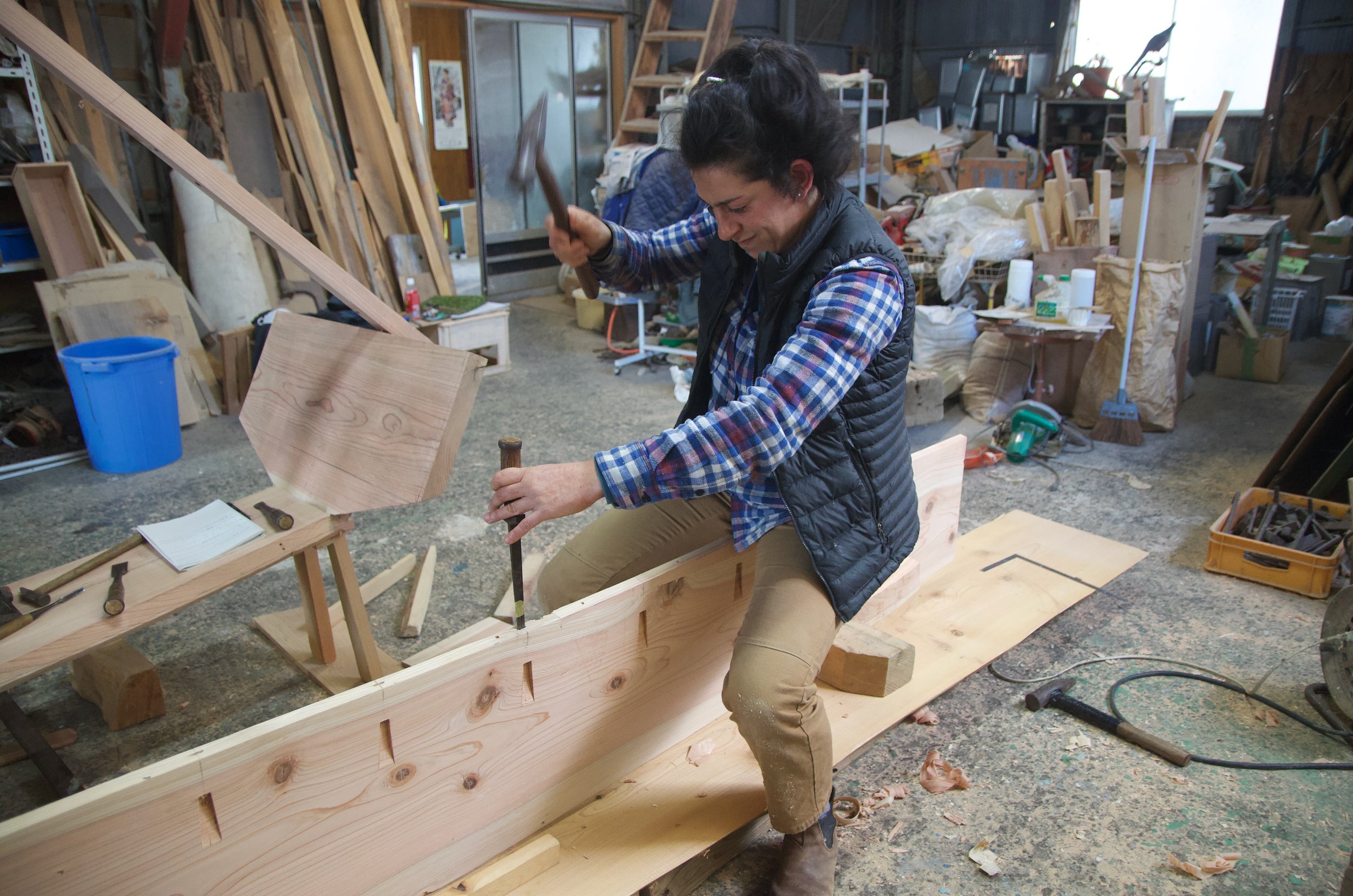 Nina Noah chisels pilot holes for our boat nails.