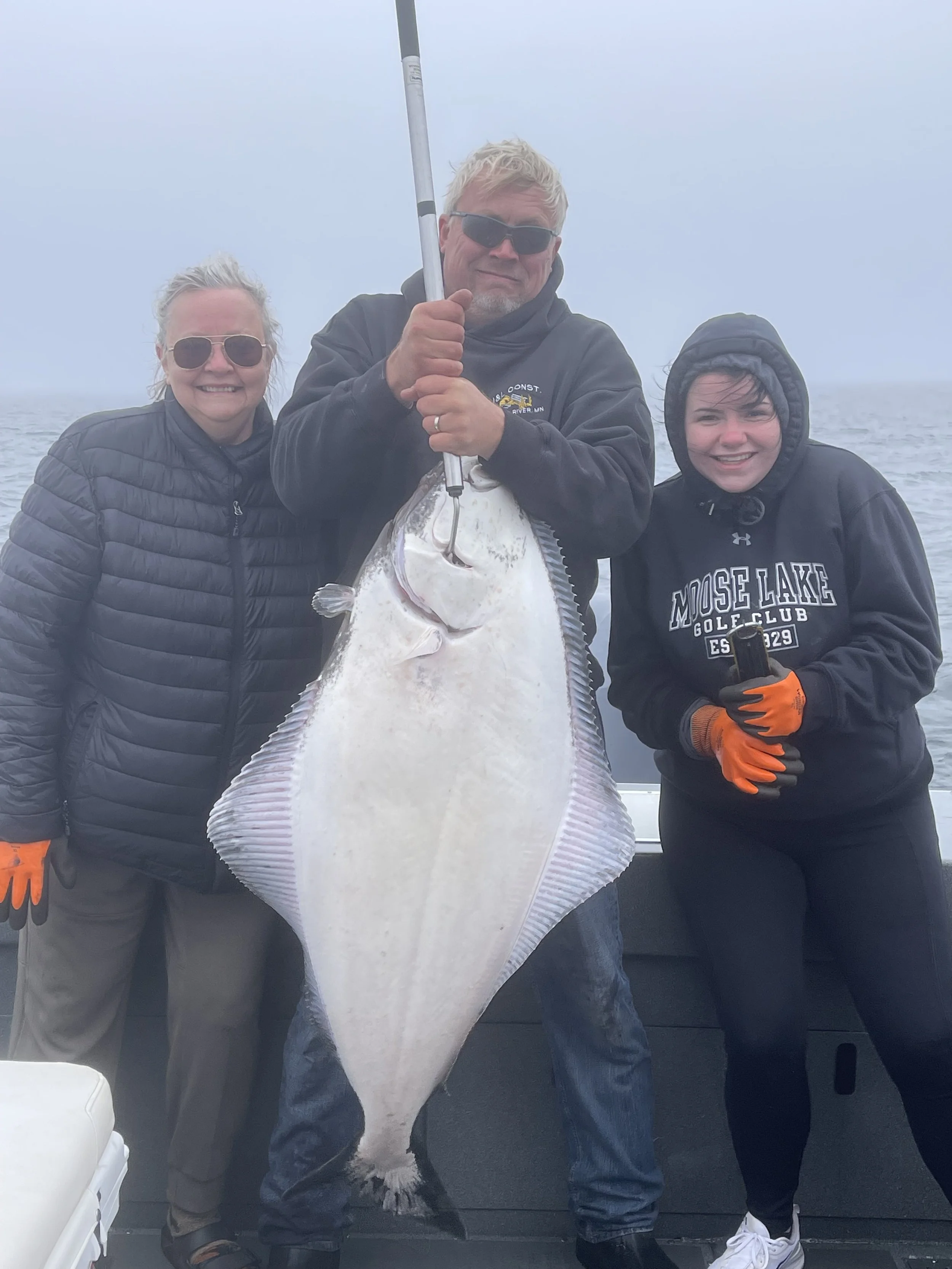 Teamwork to haul a 55# Halibut near Seldovia