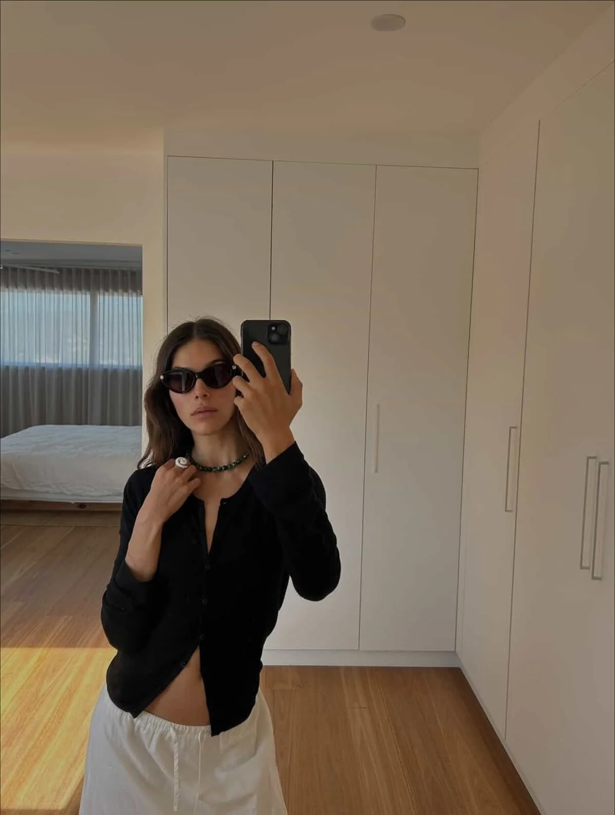 Goddess @helena.vestergaard pairing her Marble Green necklace with the Ocean&rsquo;s Curl shelly ring.