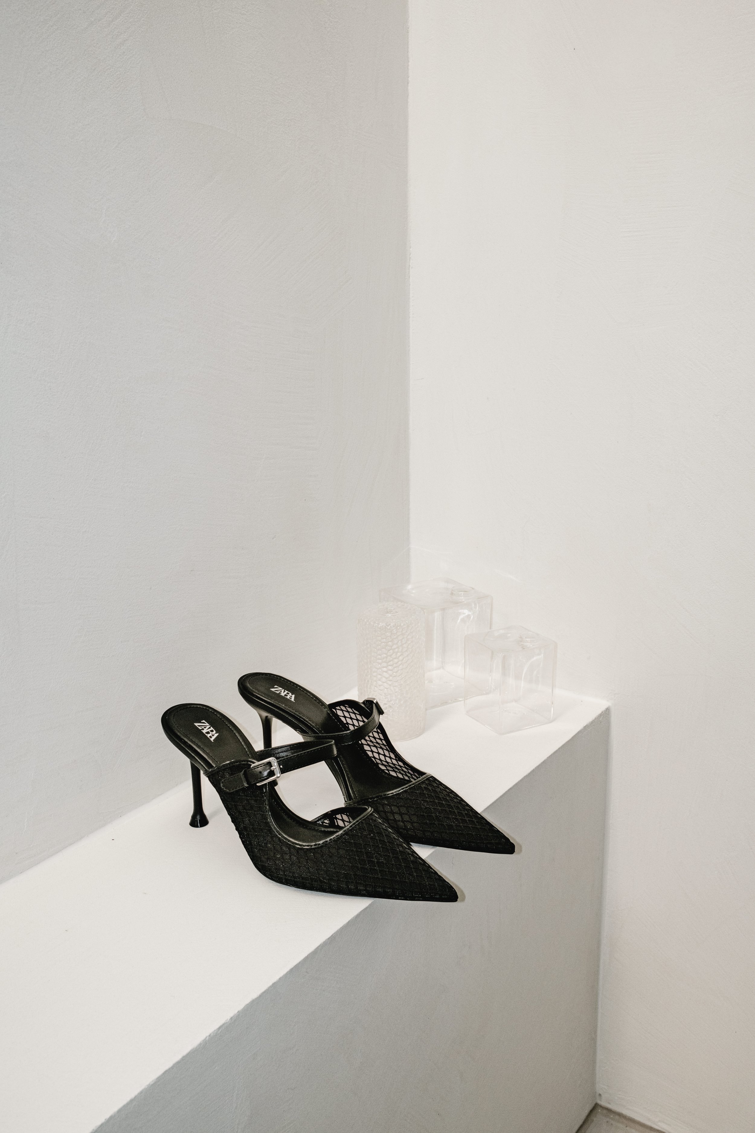 Black Shoes on White Shelf