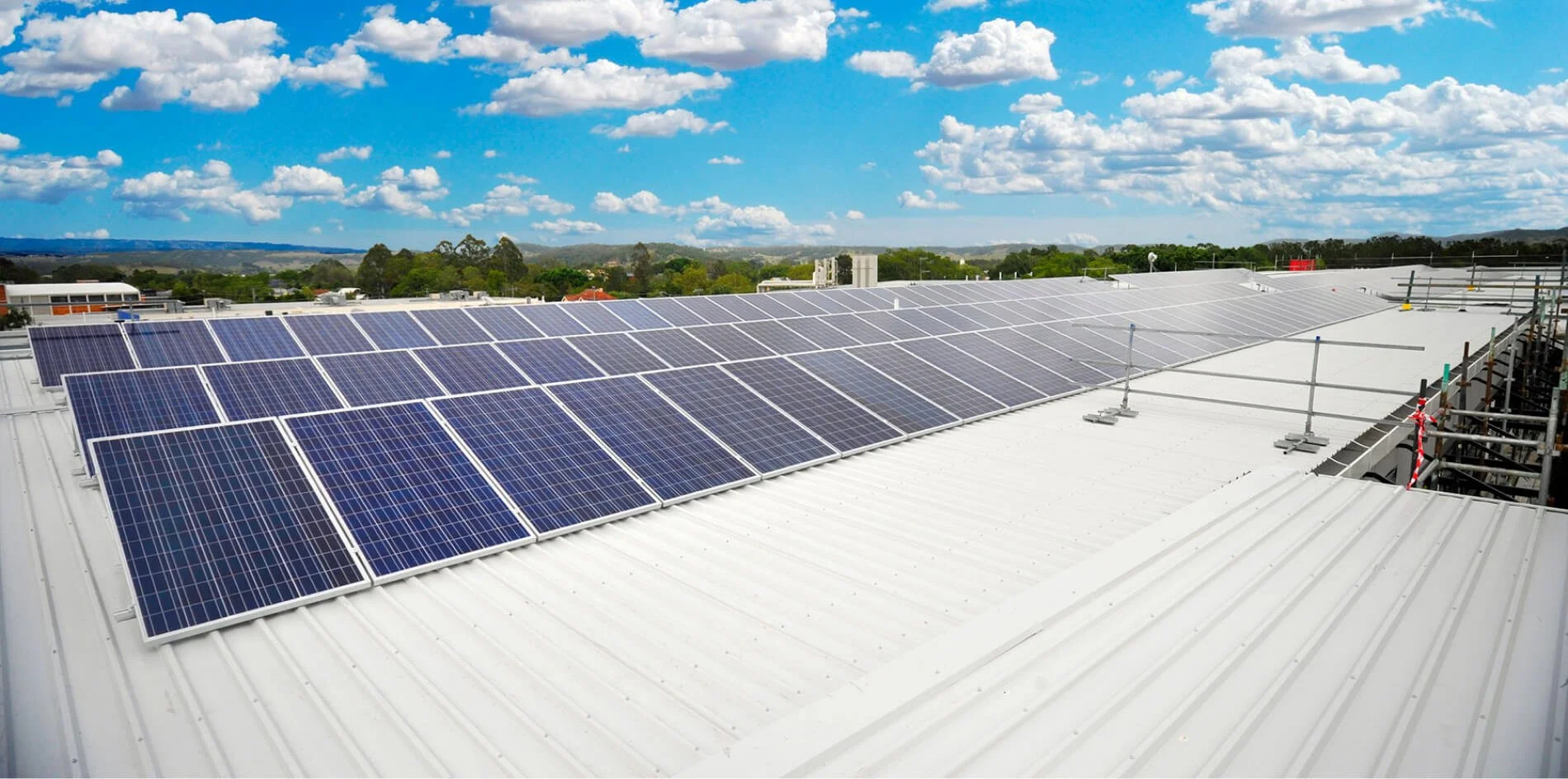 Neat row of commercial solar panels on skyline
