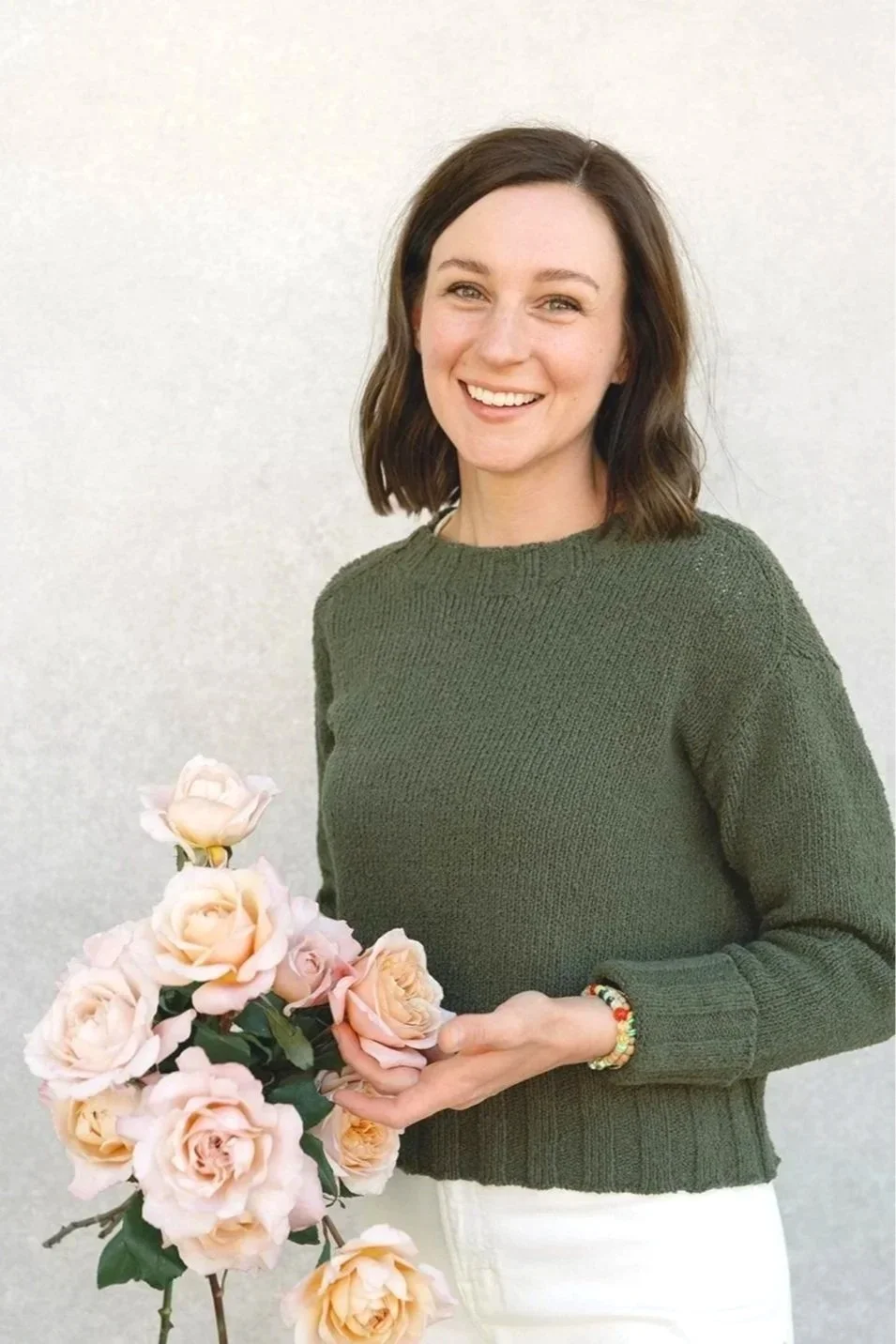 Picture of sabrina holding a bouquet of roses with text that says full event planning