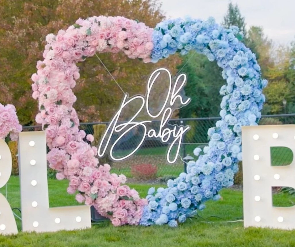 Half pink half blue flower heart arch with Oh Baby neon sign 