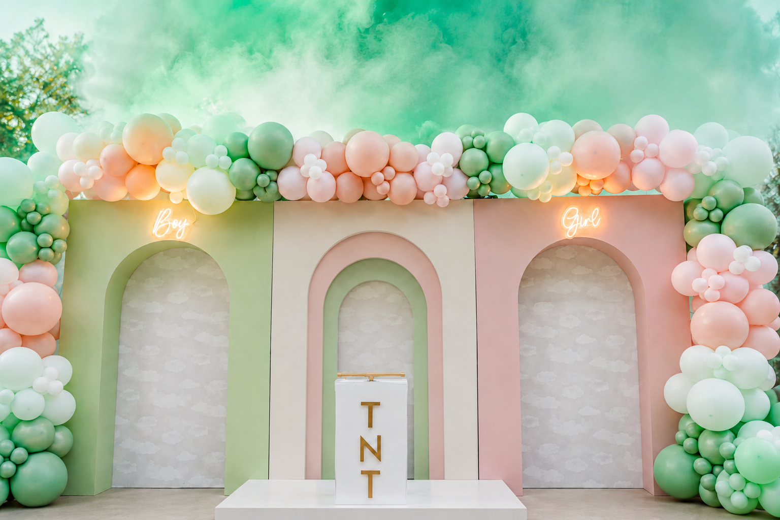 Three 3D arches with balloon garlands and Boy and Girl neon sign, with TNT box gender reveal