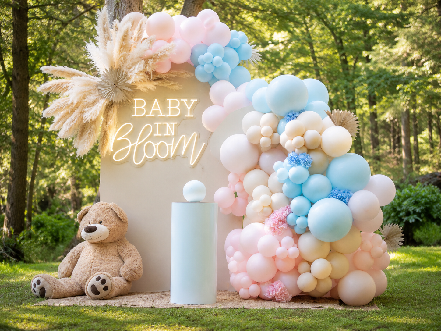  Fog color gender reveal bowl with 2 wooden backdrop arches and balloons with 'baby in bloom' neon sign