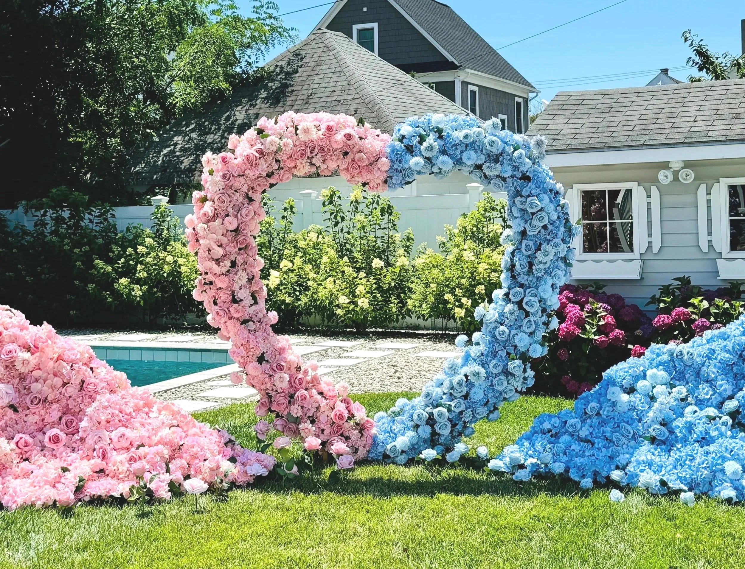 Half pink half blue flower heart arch with Oh Baby neon sign 
