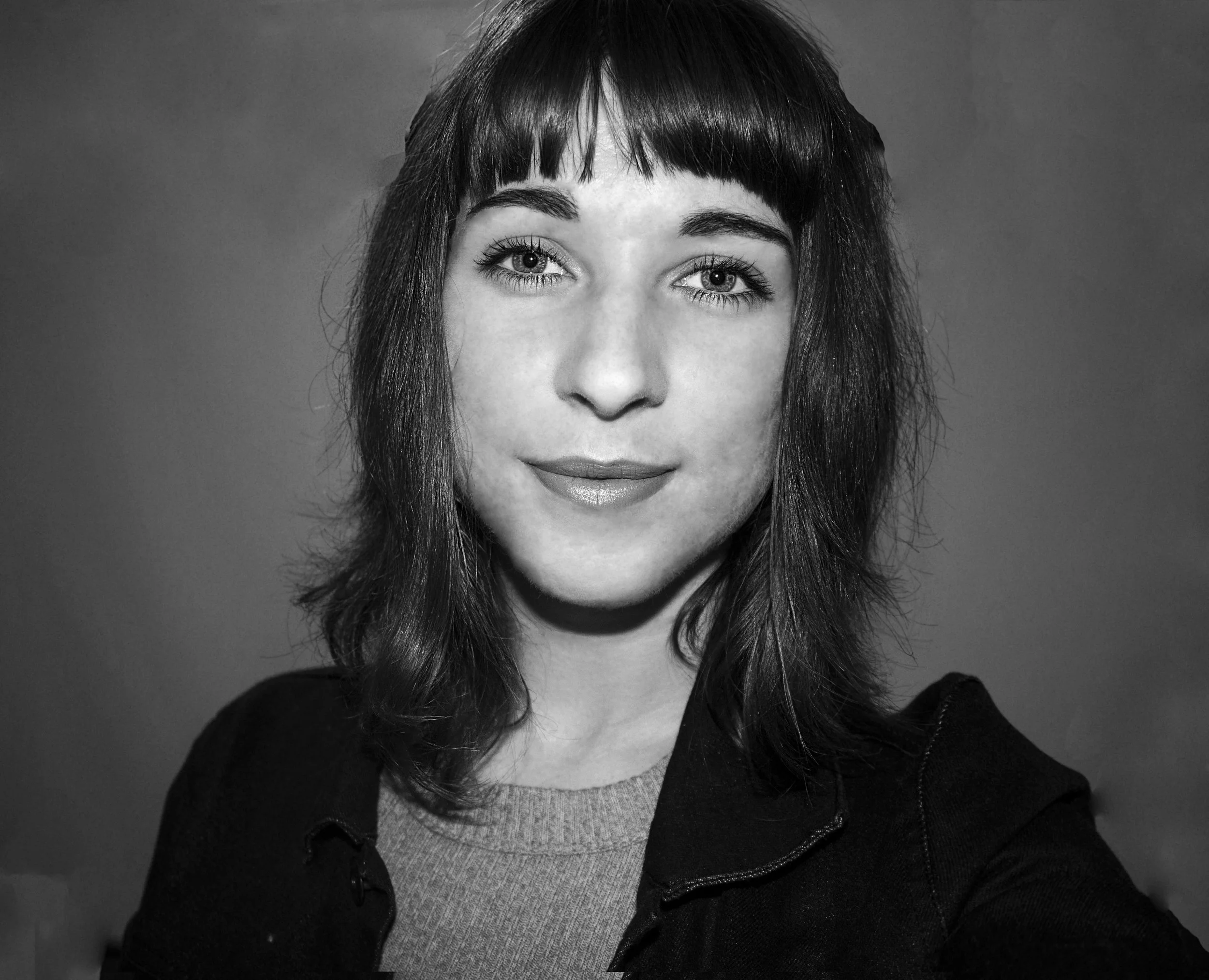 Black and white portrait of a woman with medium-length hair and bangs.