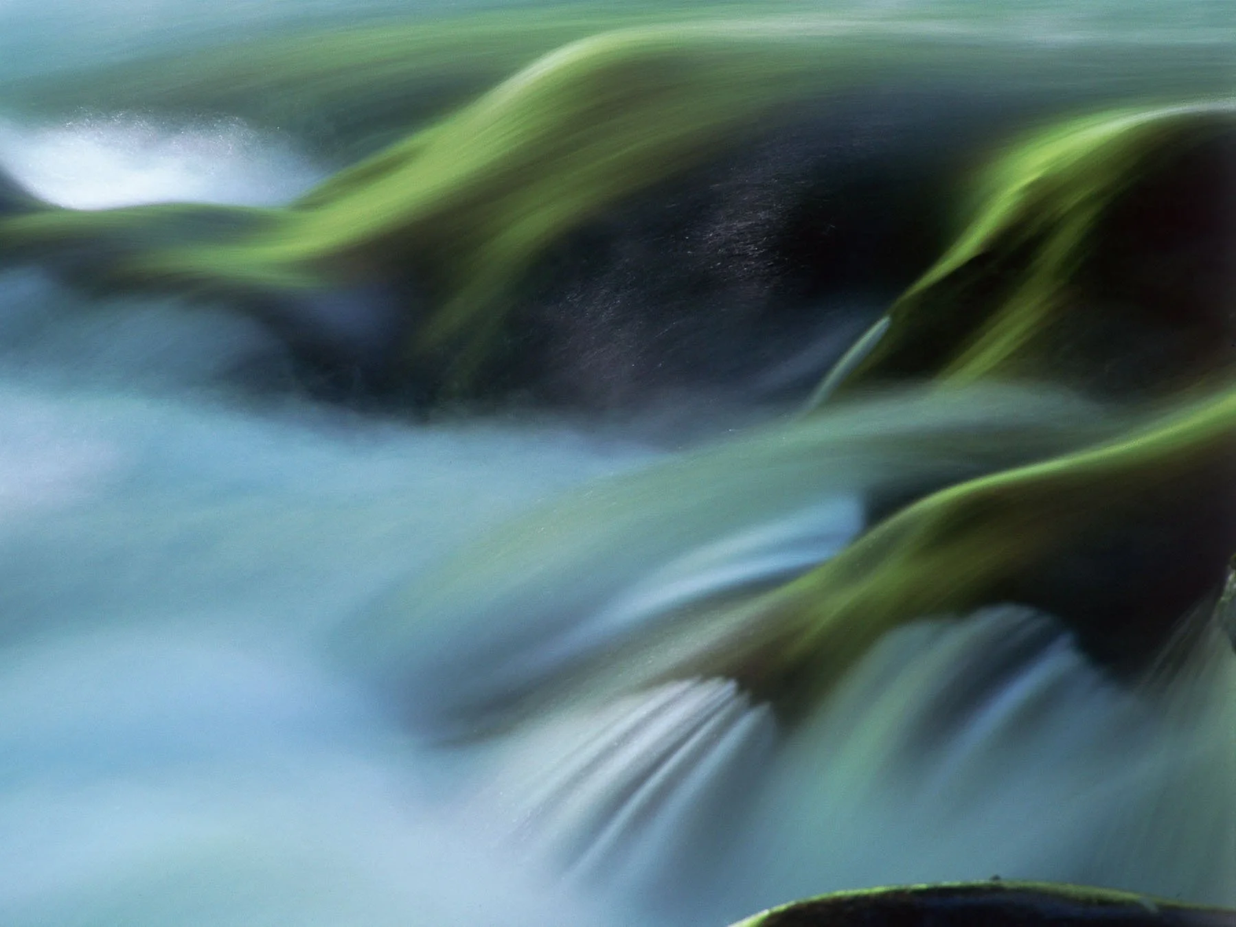 Sol Duc river over a small waterfall captured by Raj Sarda Photography