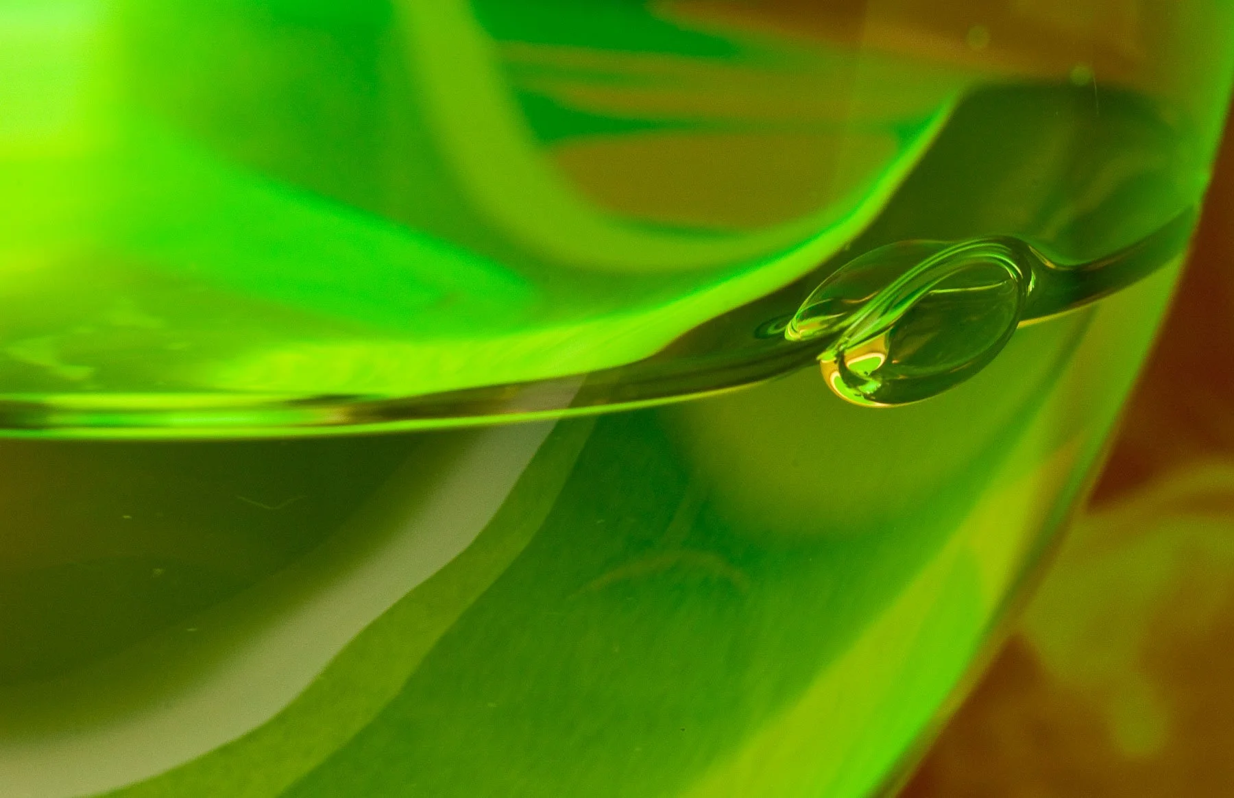Reflection of a wine bottle swirled in wine glass captured by Raj Sarda Photography