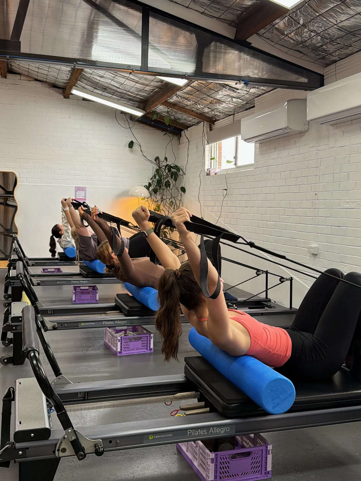 People attending a pilates foam roller class