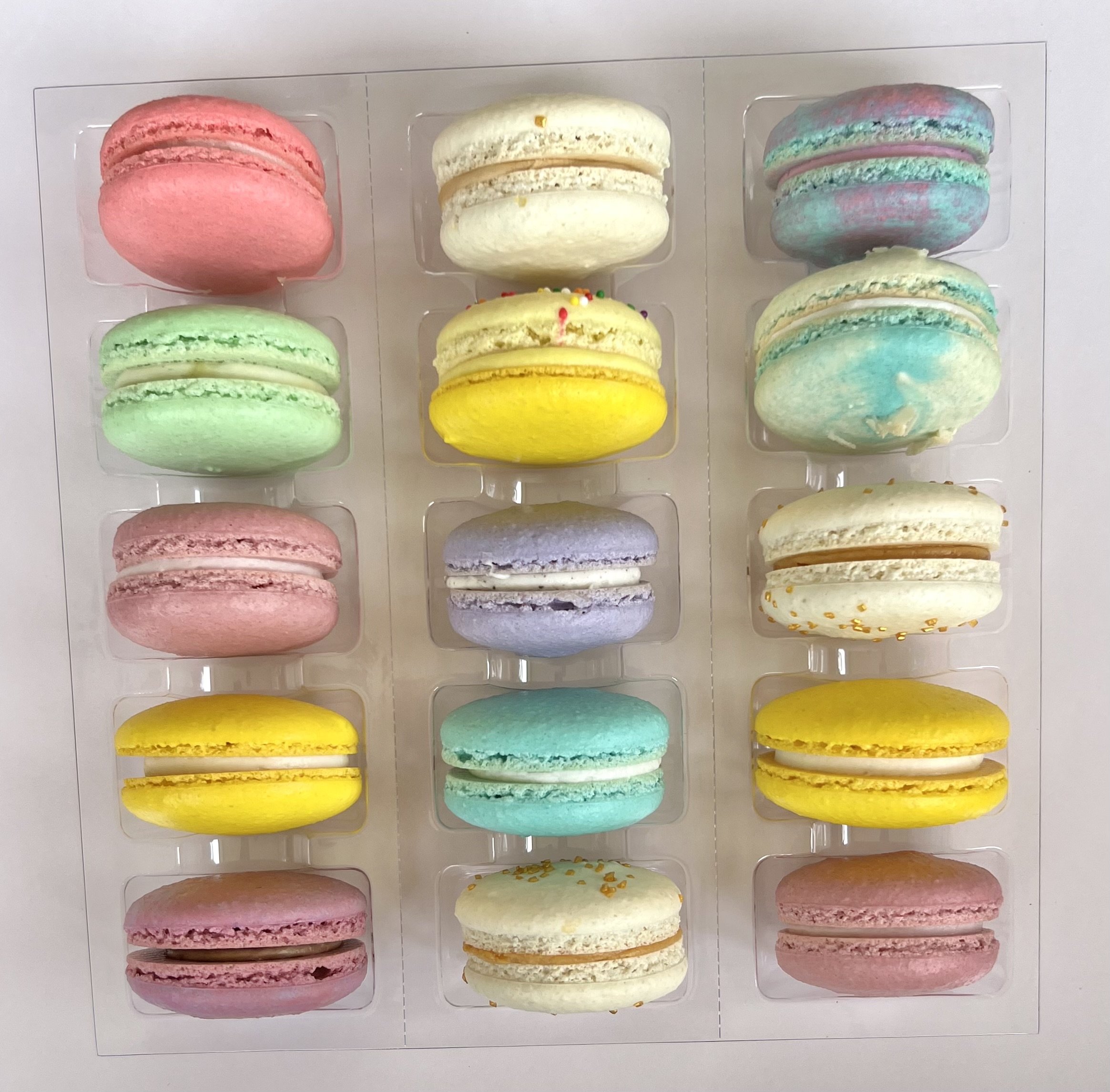 Colorful macaron box with custom flavors from Delicate Delights Baking Co