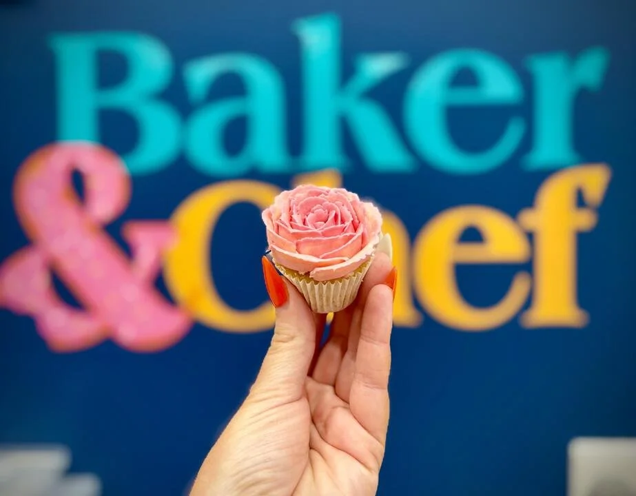Mini light pink rose cupcake with Baker & Chef sign in background