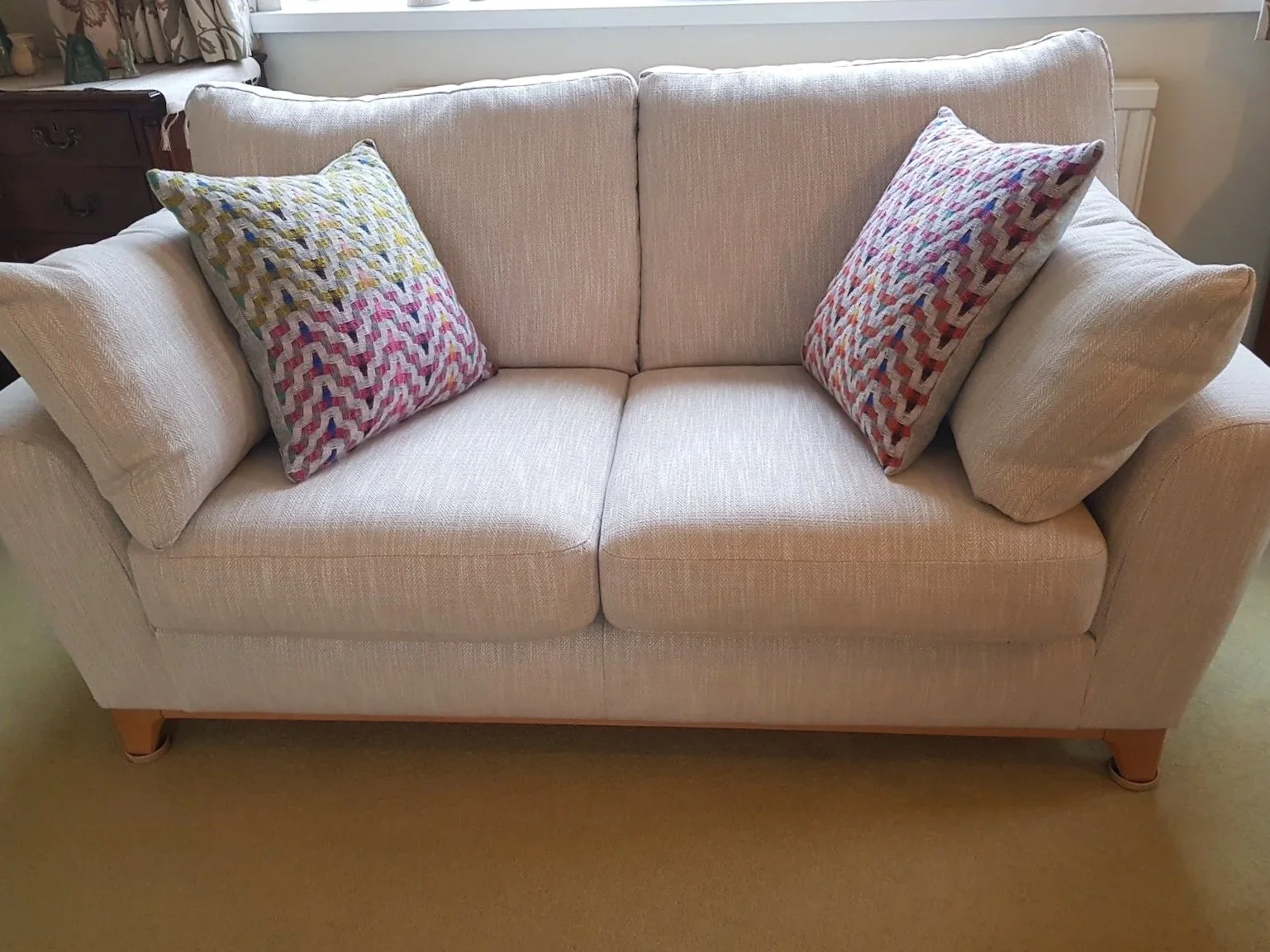 Fuchsia cushions on neutral sofa