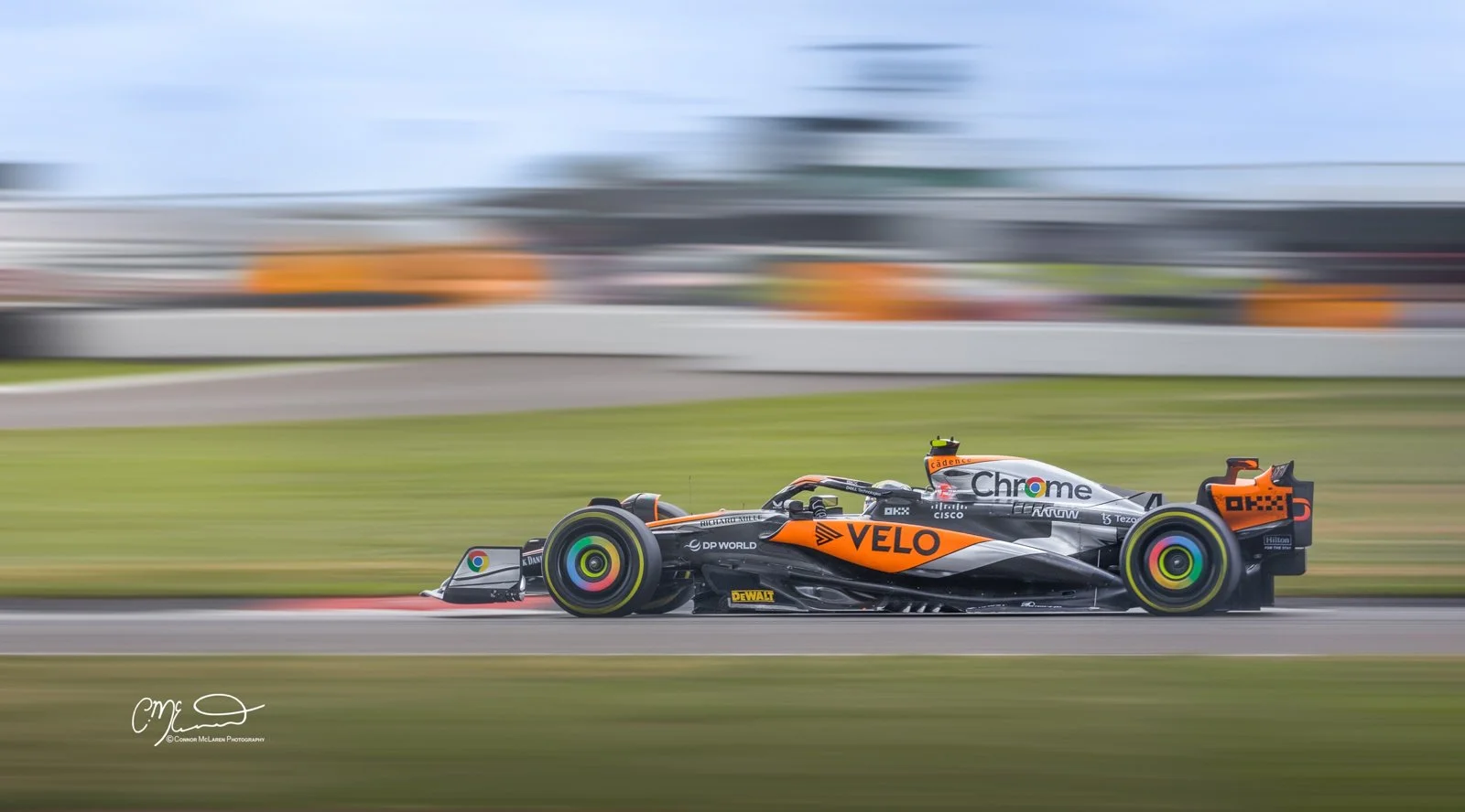 Formula One, World champion Lando Norris, McLaren F1 car racing at Silverstone in limited edition livery for one race only. A racing car speeding on a track with motion blur in the background.