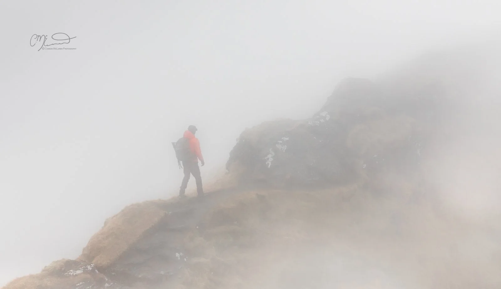 Scottish Central Highlands, Scotland, Perthshire munro. A person with a backpack walking along a foggy mountain trail