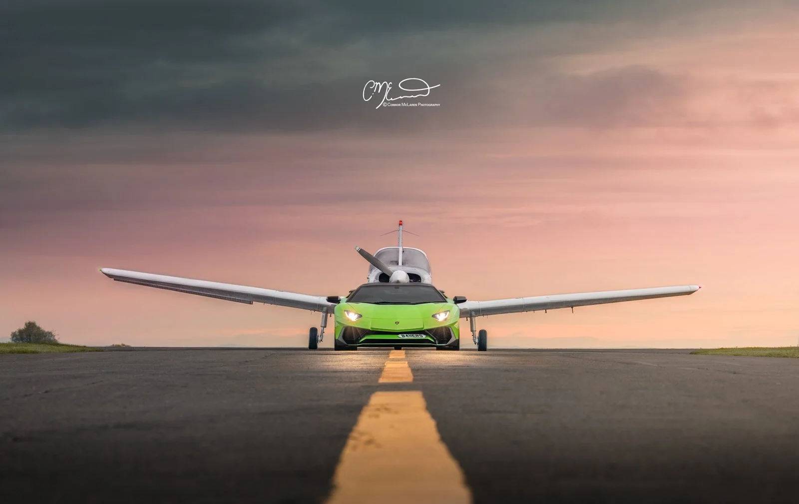 lamborghini Aventador SV Roadster in Green on airport runway with Private jet at sunrise. A green sports car and a white drone aircraft on an empty runway at sunset, viewed from the front.