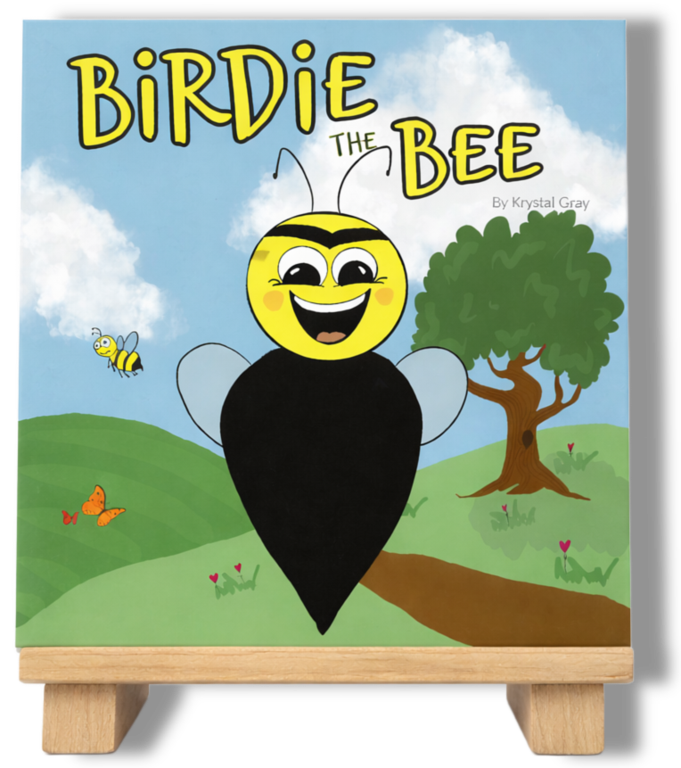 Book cover titled 'Birdie the Bee' by Krystal Gray, featuring a cartoon bee with a smiling face, large eyes, and yellow and black stripes, flying in a green landscape with a tree, butterflies, and a blue sky with clouds.
