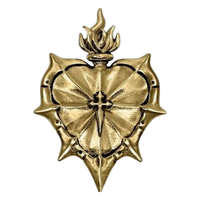 Gold sacral heart with a cross in the middle.