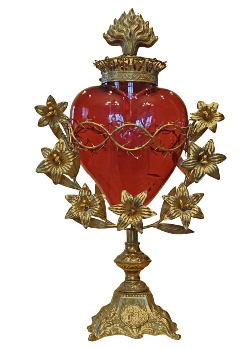 A heart shaped lamp with a red shade and gold stand.