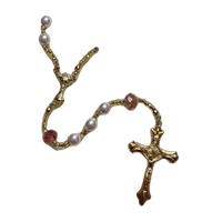 A gold rosary with pearls.