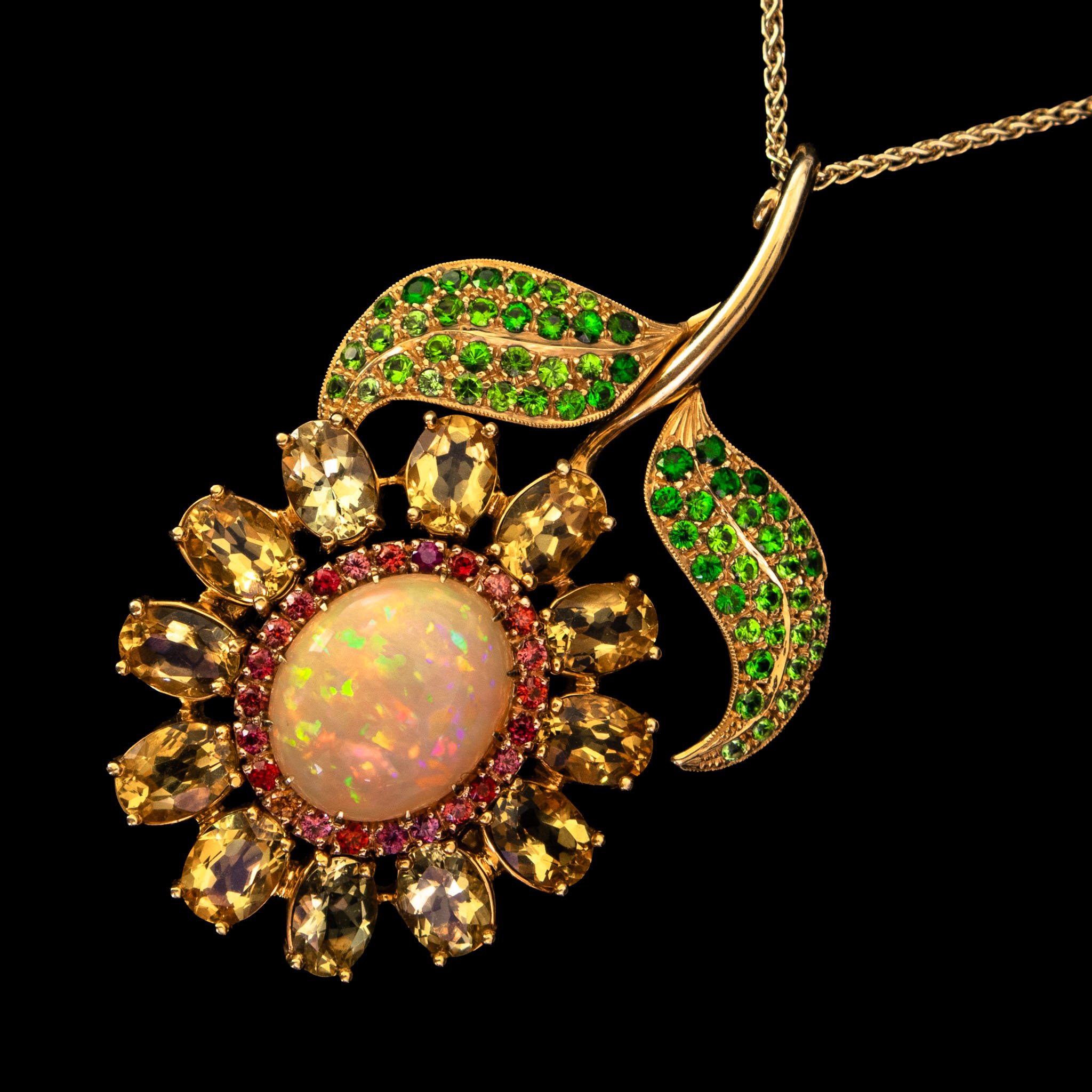 Interchangeable pin and pendants. Ethiopian Opal, fancy colored sapphires, golden beryls, tsavorite garnets. 18 kt yellow and rose gold. Additional diamonds and single tsavorite garnet. 