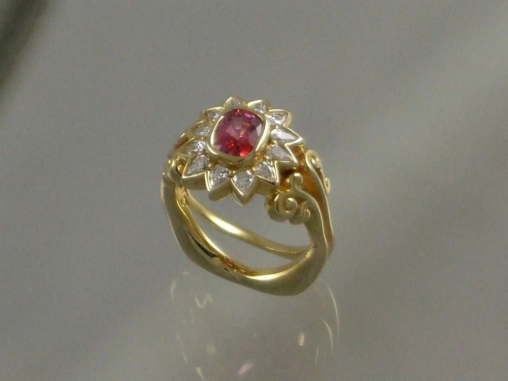 1.16 ct color change Sapphire. 12 pear shaped diamonds 18 kt gold.