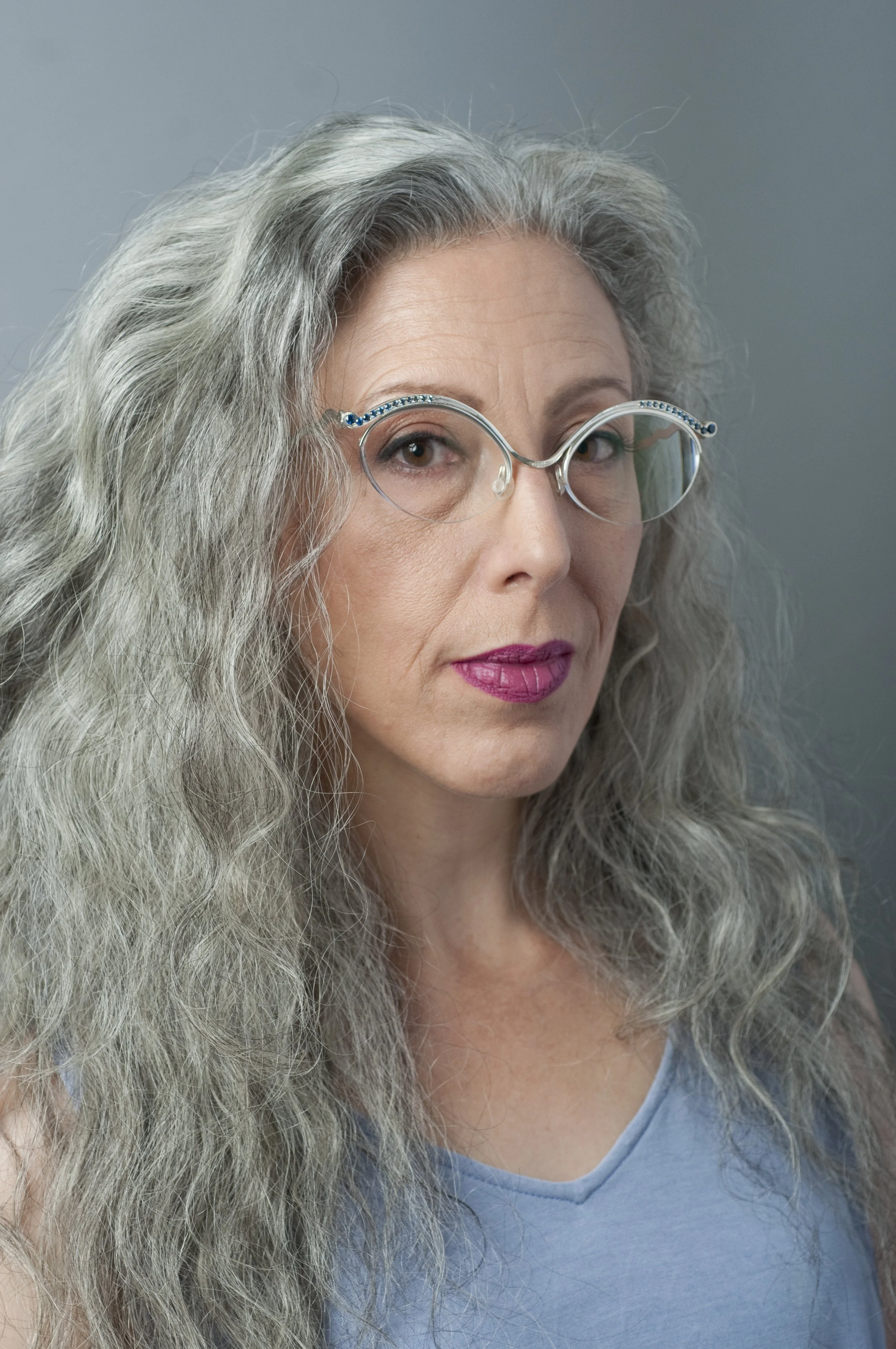 Eyeglass frames 24 sapphires in descending size and color. Continuum silver.