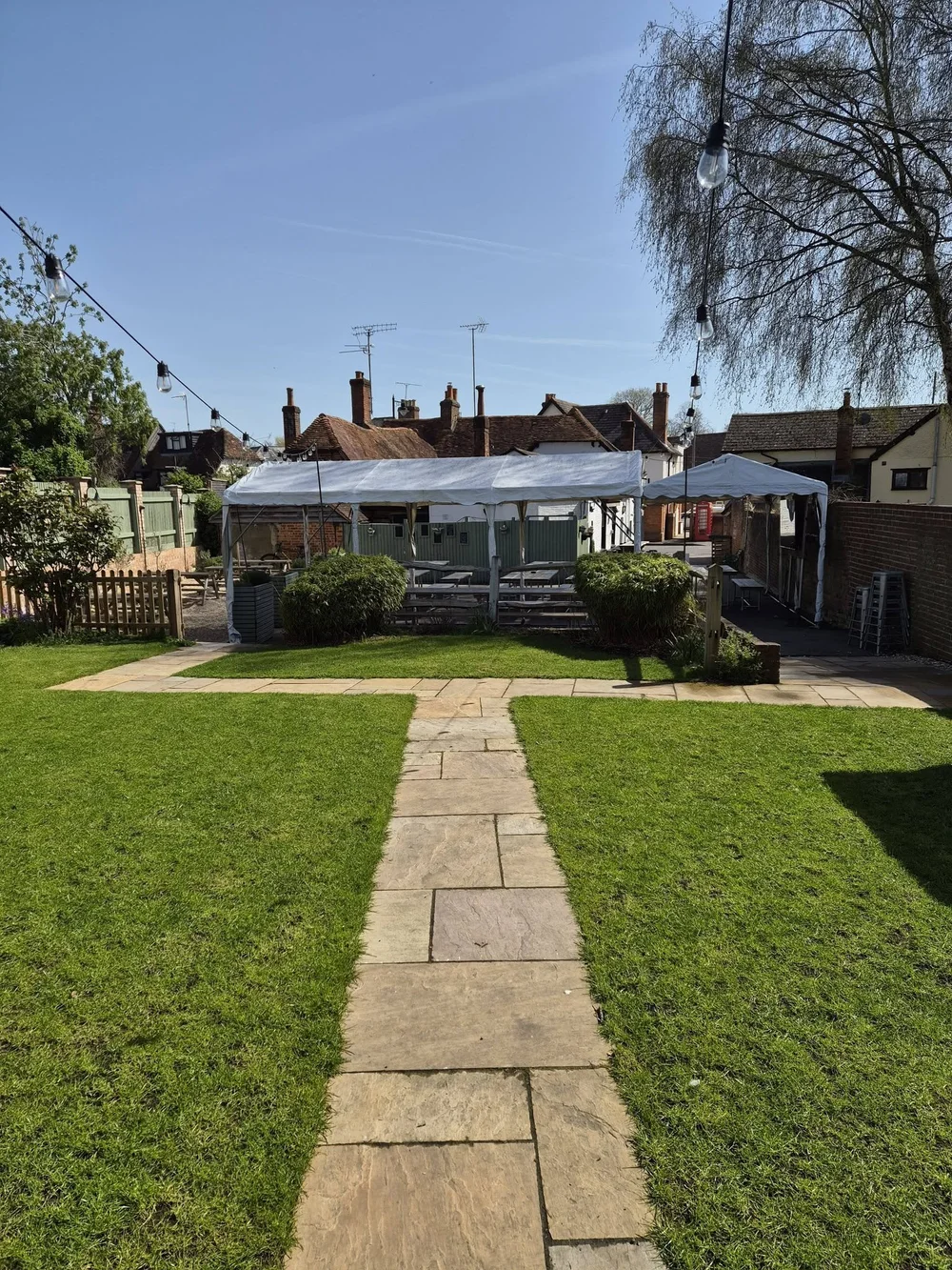 View across the garden lawn towards the covered seating at the Kings Arms