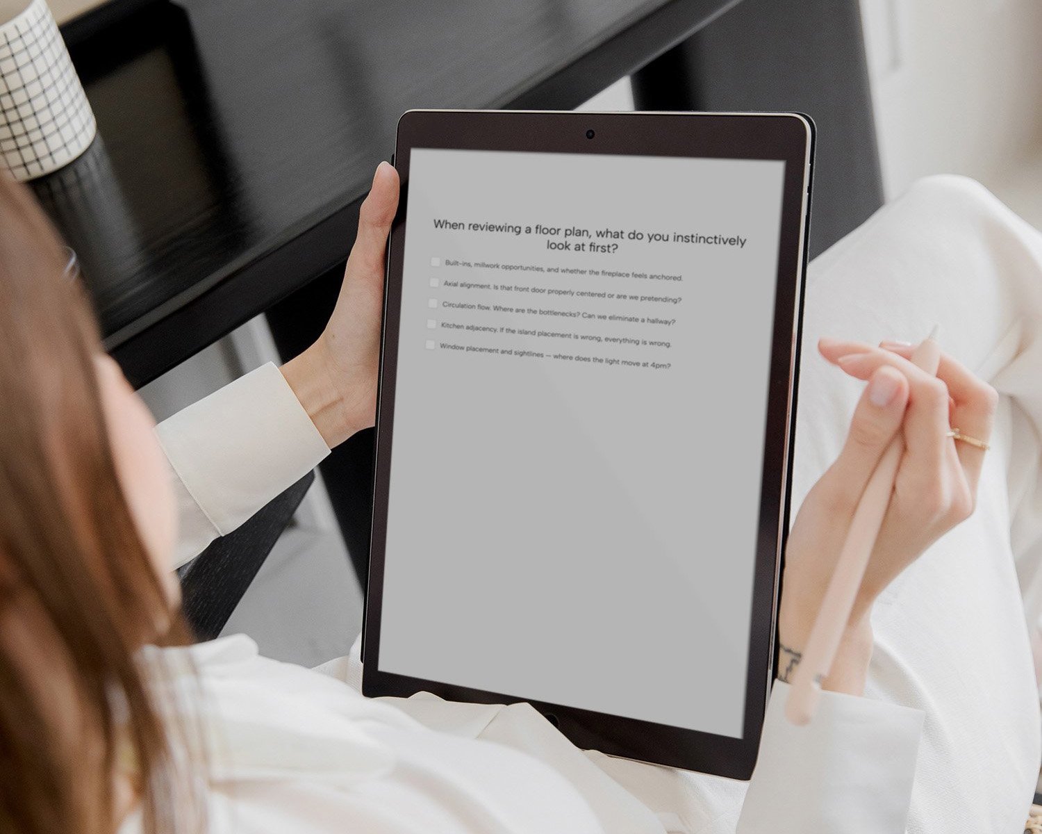 woman in an elevated, neutral office setting taking an online quiz on her tablet
