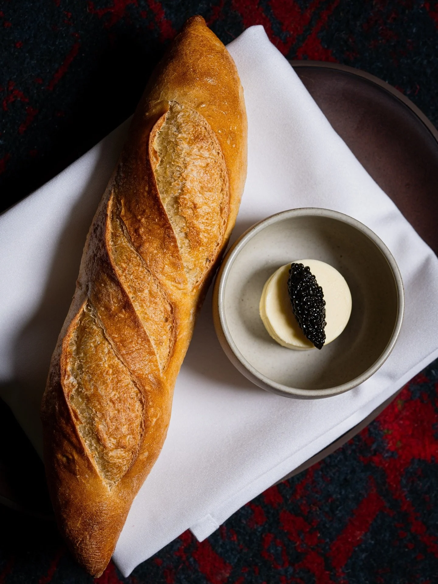 Golden and crackling at the crust, light and cloud soft within, our baguettes are baked fresh daily, each one hand stretched and scored before meeting the oven. Each week, hundreds emerge from the oven, waiting to be layered with Pamplie Butter, Chic