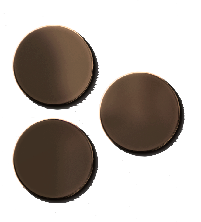 Three dark brown circular pills with smooth surfaces, arranged on a black background.