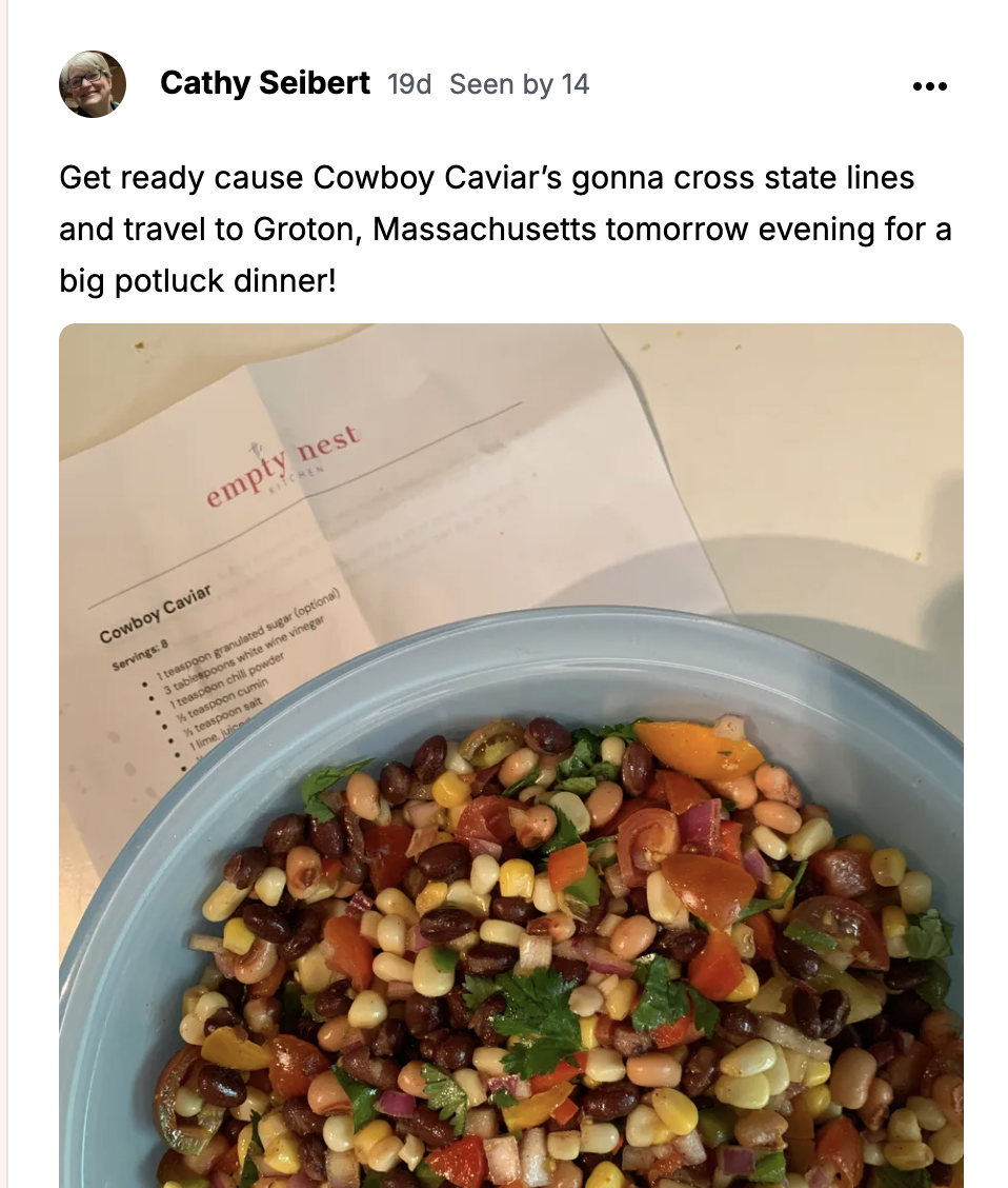 Cowboy Caviar in a pale blue bowl beside the printed Empty Nest Kitchen recipe card.