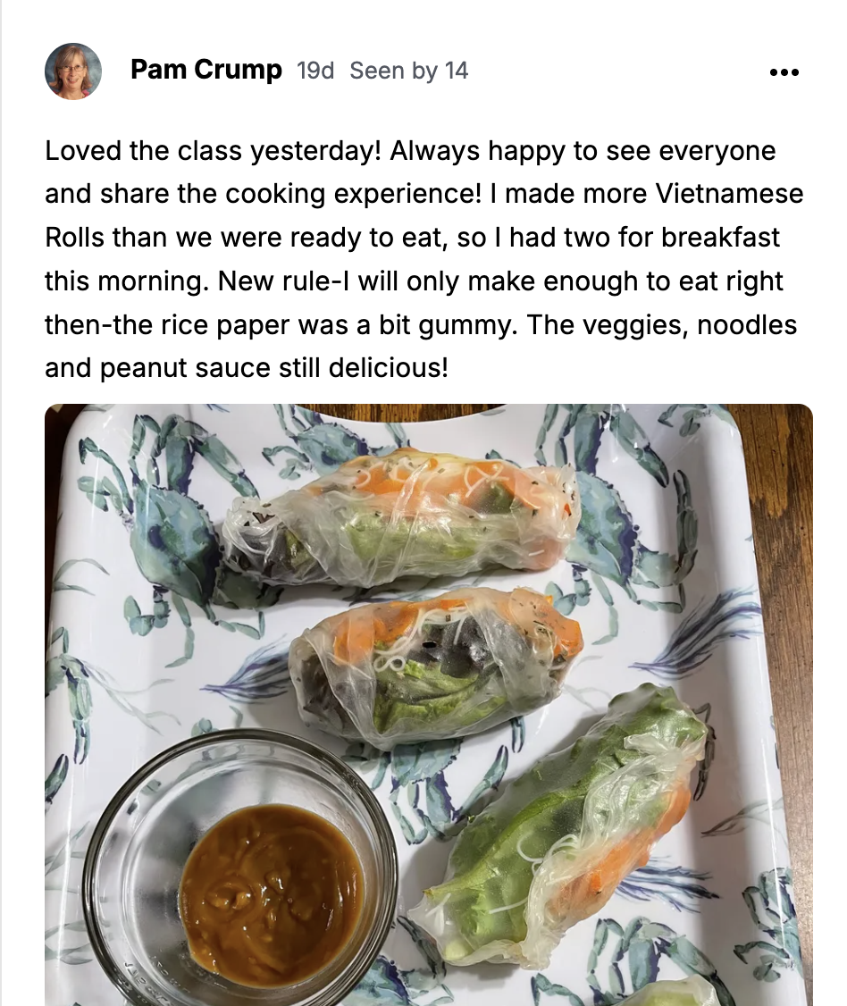 Vietnamese rice paper rolls on a crab-patterned platter with a bowl of peanut sauce.