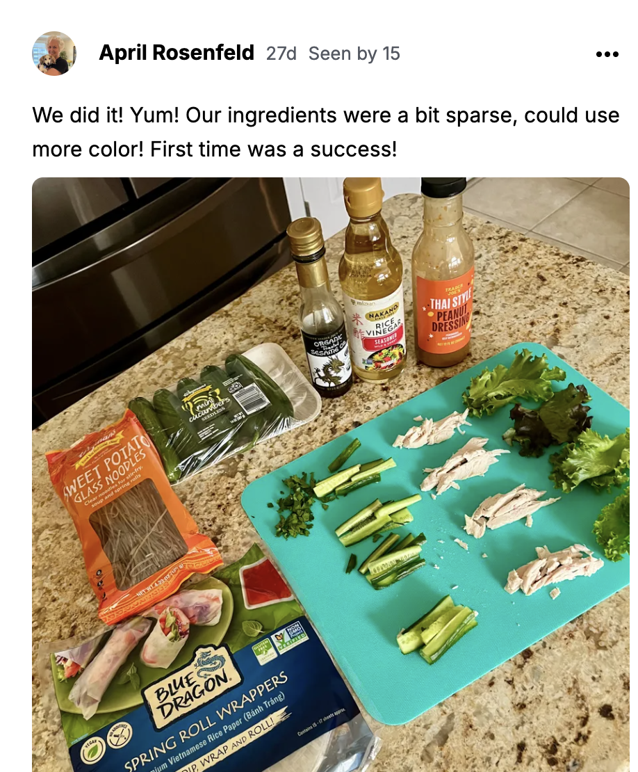 Spring roll ingredients laid out on a teal cutting board: rice paper wrappers, vinegars, peanut dressing, greens and sliced chicken.