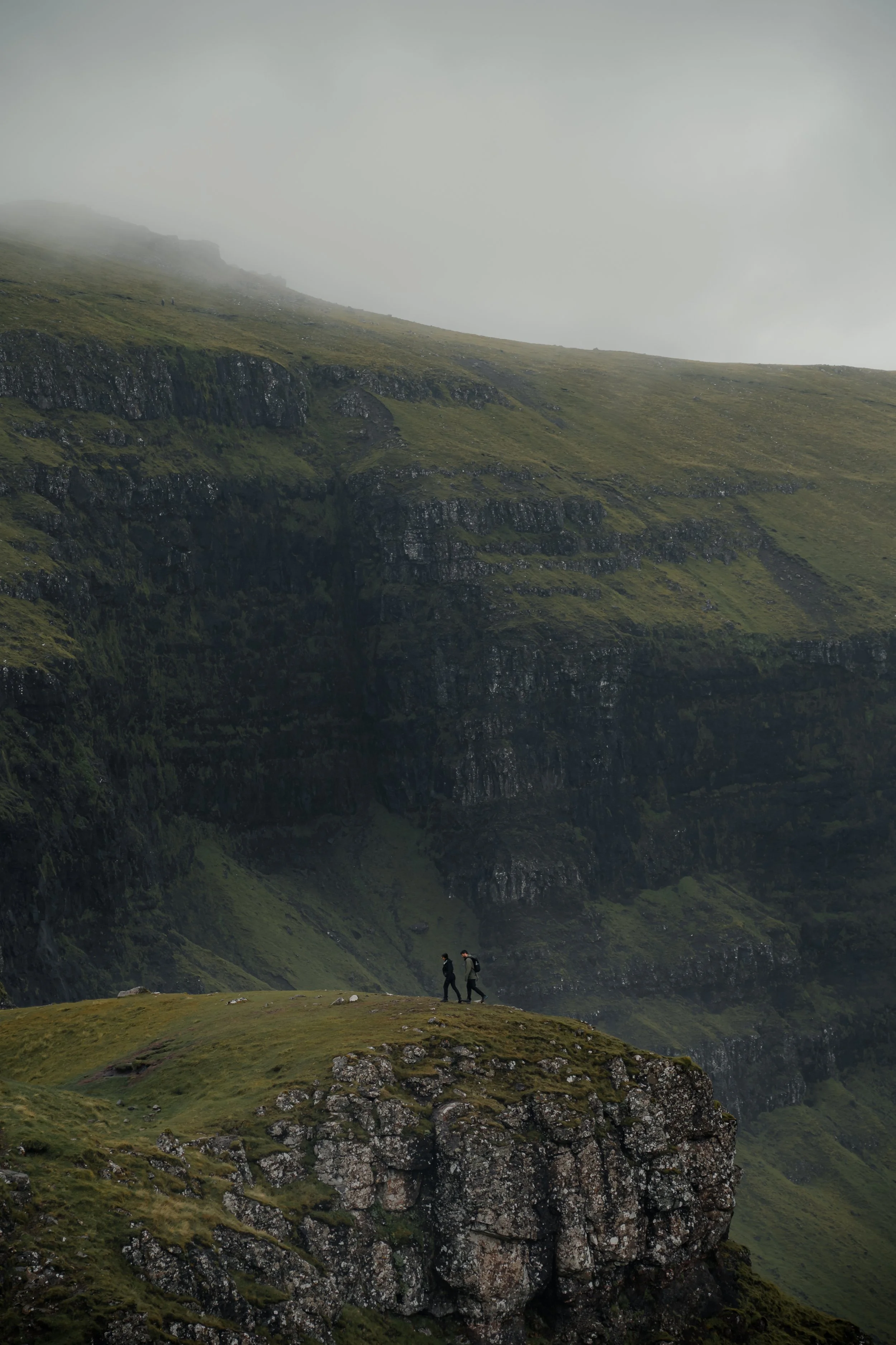 Lone walker surrounded by dramatic mountains on the Isle of Skye, Scotland
