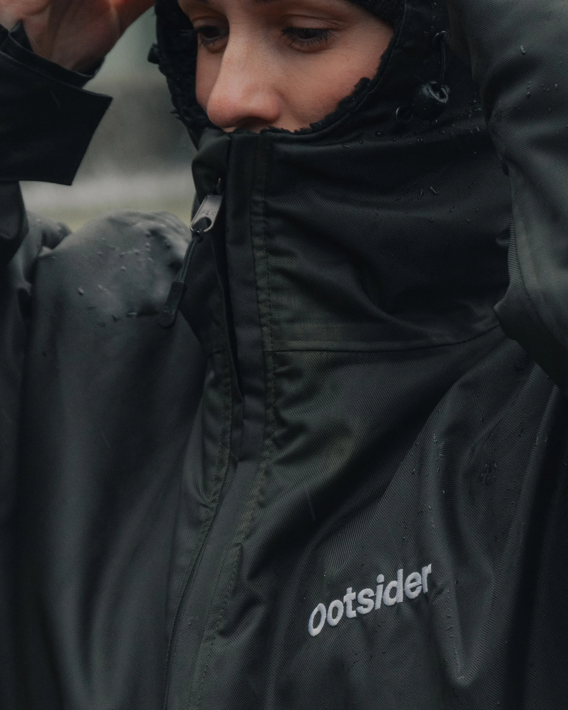 The Ootsider jacket photographed against Edinburgh architecture, highlighting urban outdoor clothing and social impact design.