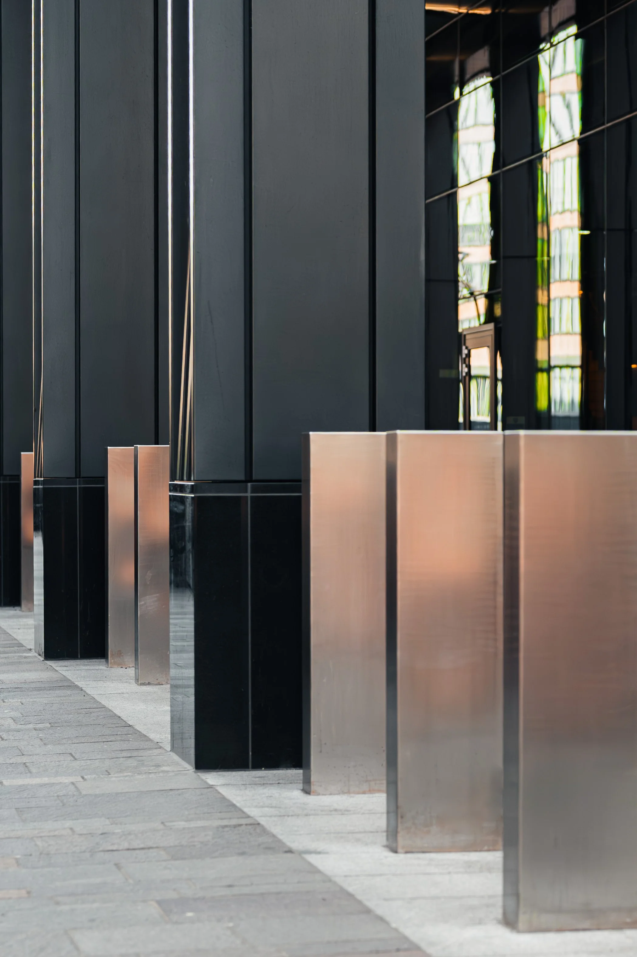 Close-up of black stone façade detail at JP Morgan building highlighting texture and material finish.