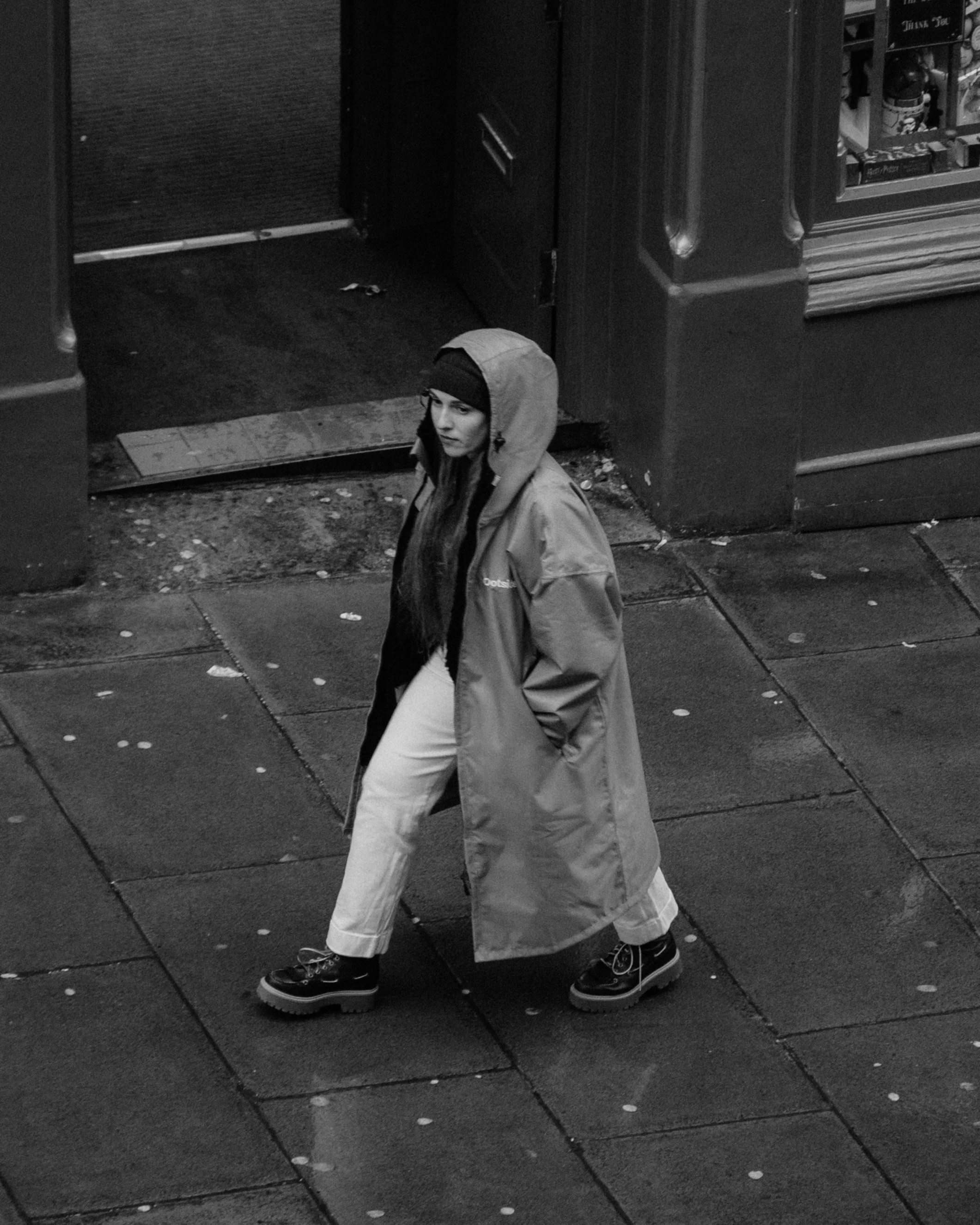 The Ootsider jacket photographed against Edinburgh architecture, highlighting urban outdoor clothing and social impact design.