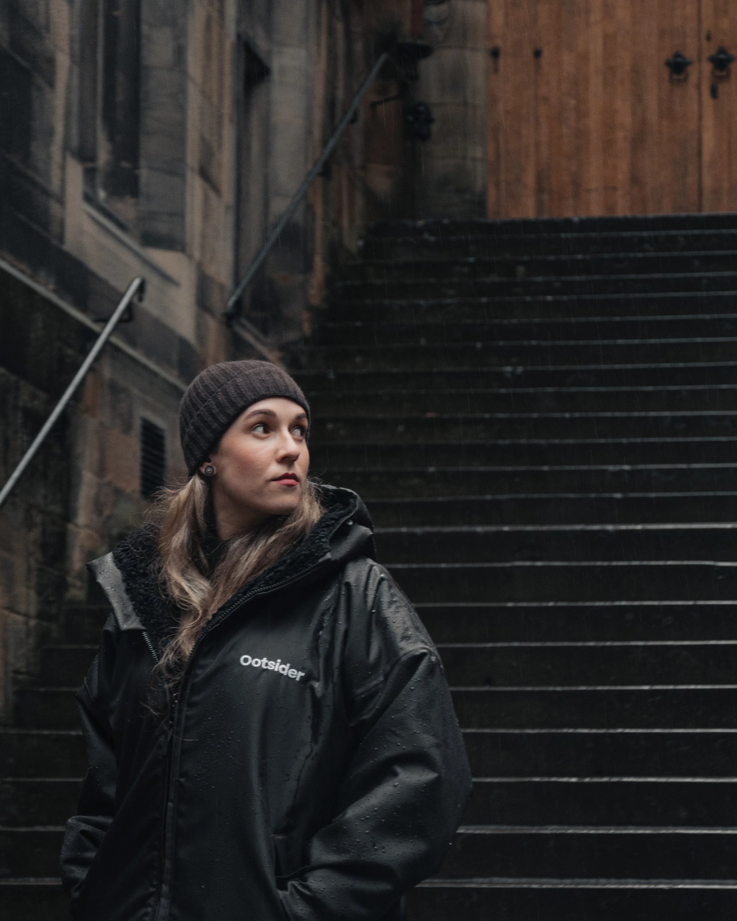 The Ootsider jacket photographed against Edinburgh architecture, highlighting urban outdoor clothing and social impact design.