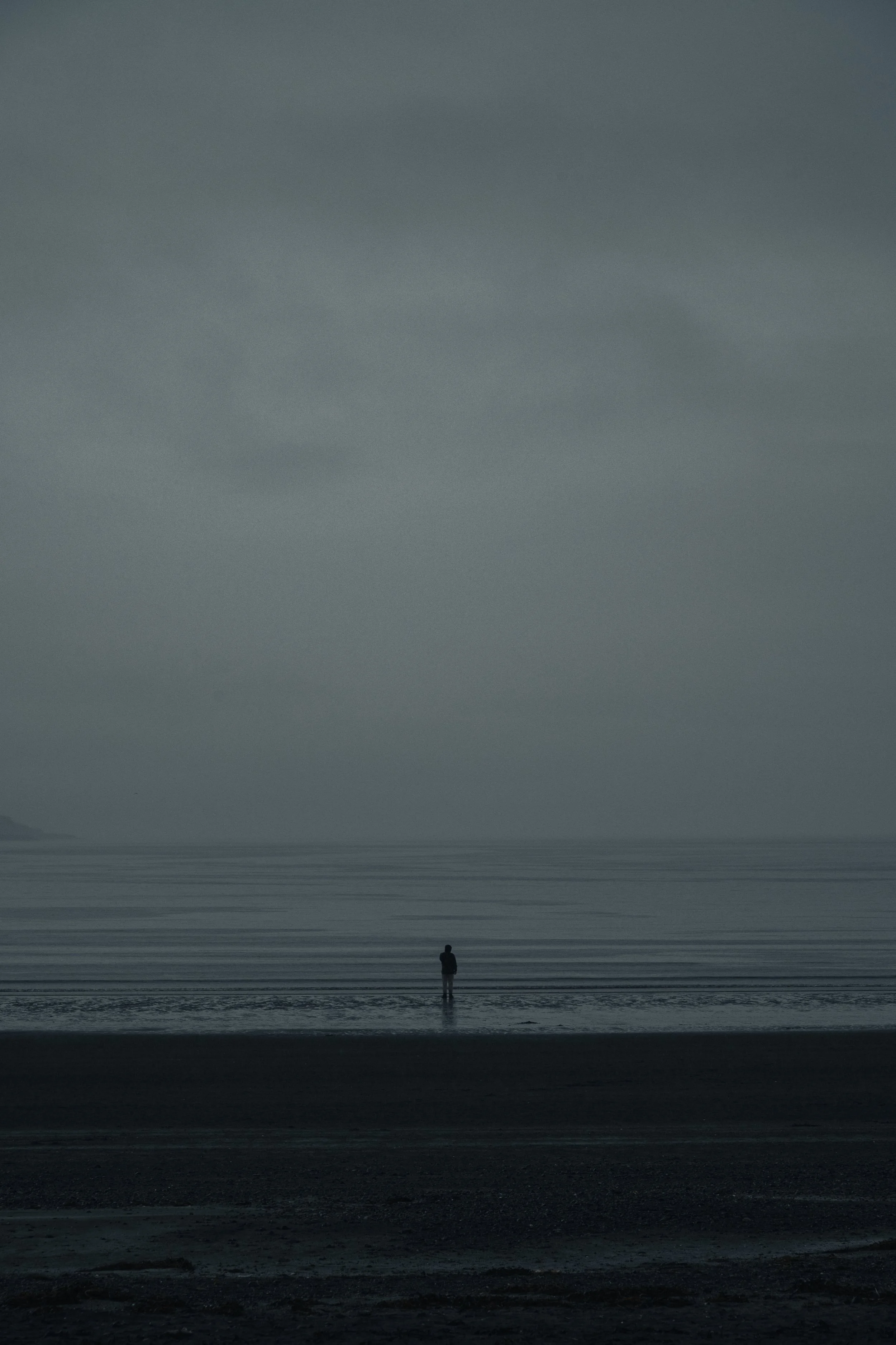 Silhouette of a person walking through the Isle of Skye landscape