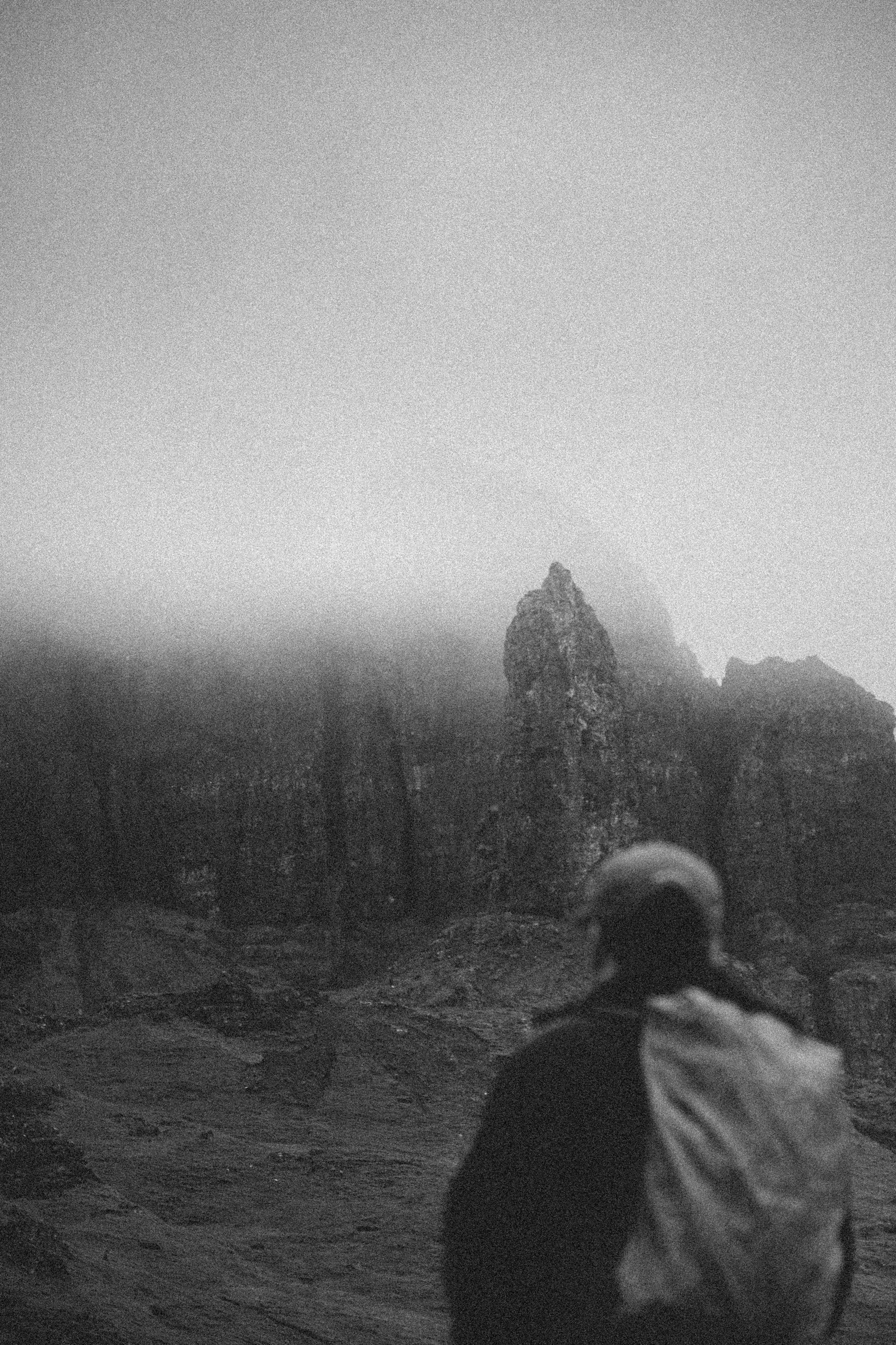 Lone walker surrounded by dramatic mountains on the Isle of Skye, Scotland