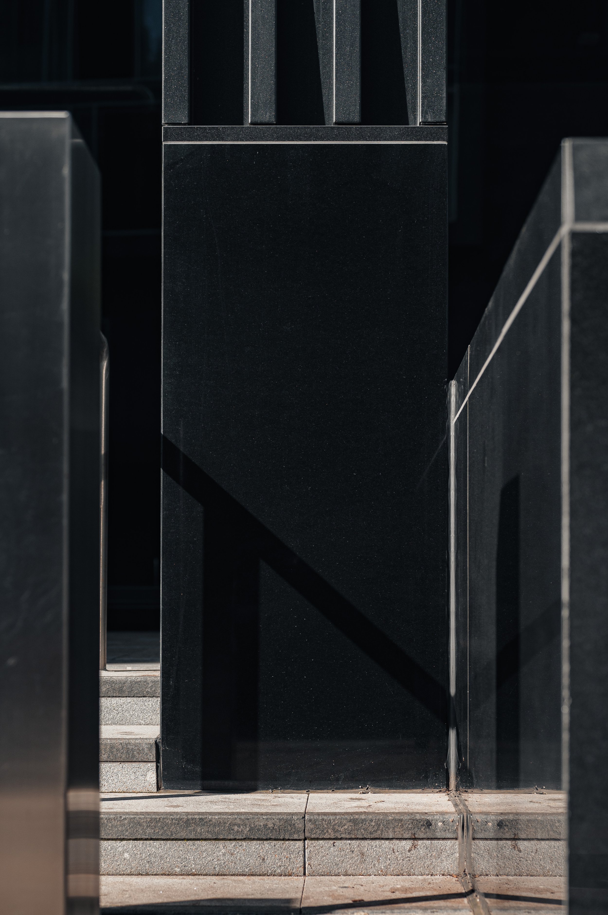 Close-up of black stone façade detail at JP Morgan building highlighting texture and material finish.