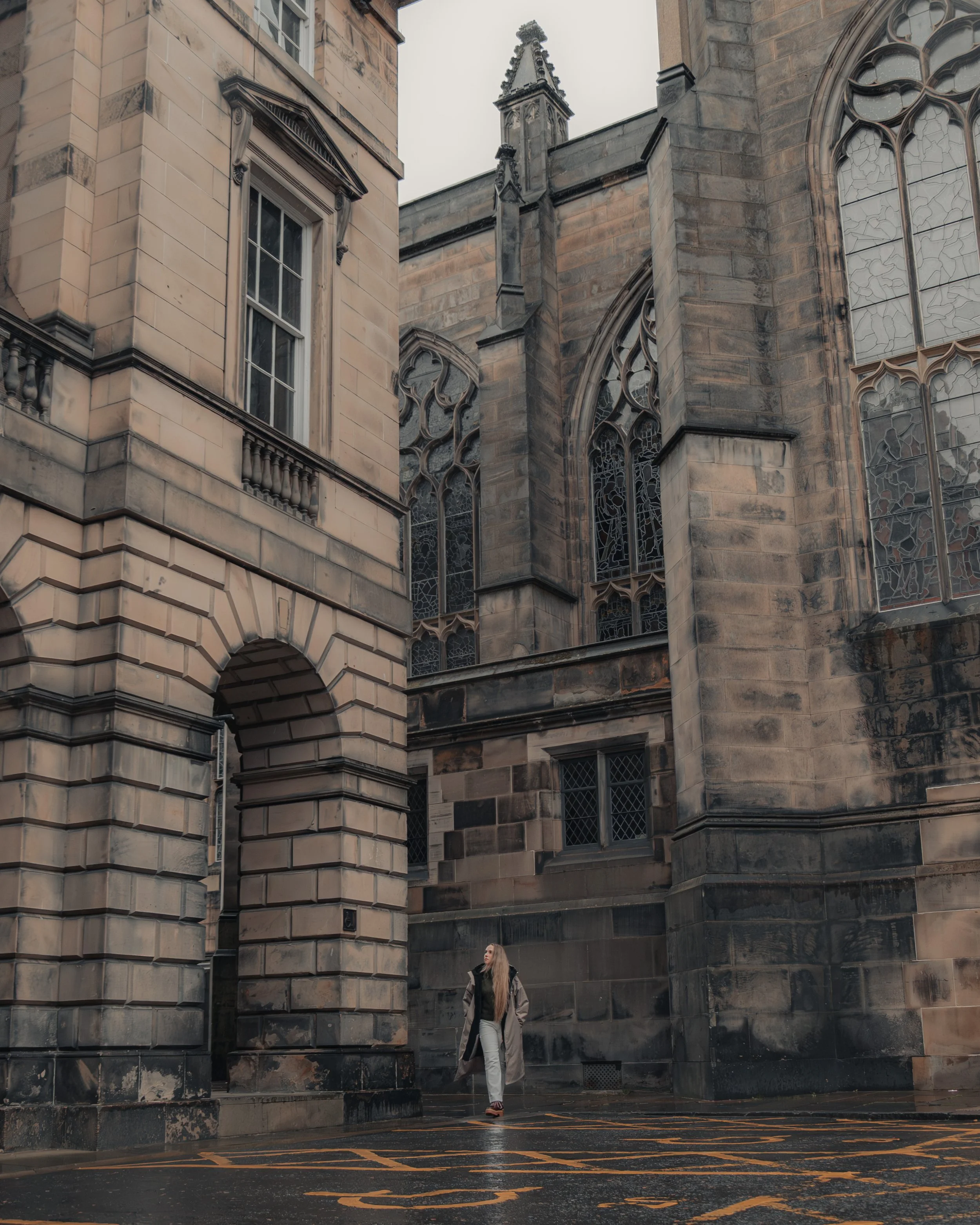 The Ootsider jacket photographed against Edinburgh architecture, highlighting urban outdoor clothing and social impact design.