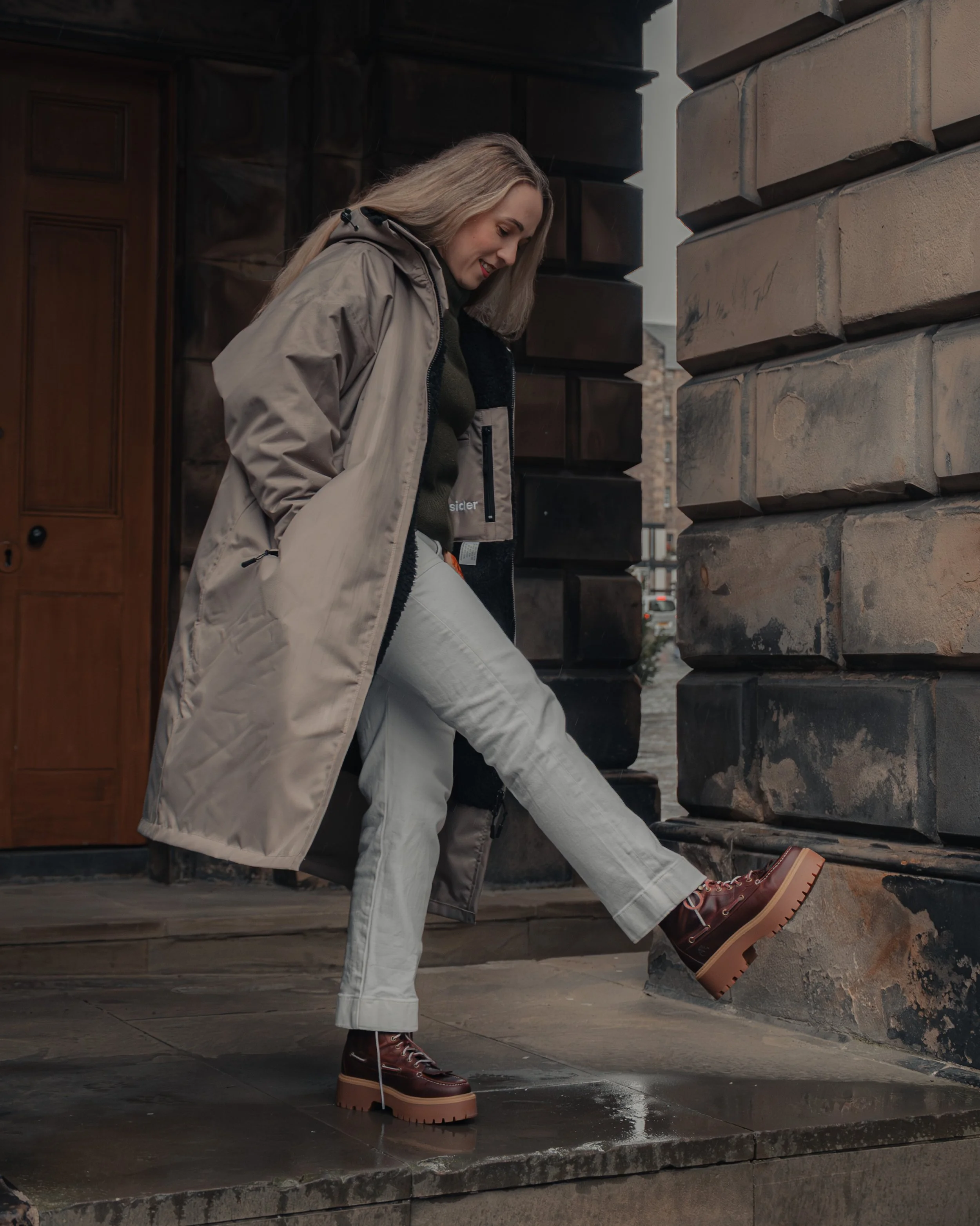 The Ootsider jacket photographed against Edinburgh architecture, highlighting urban outdoor clothing and social impact design.