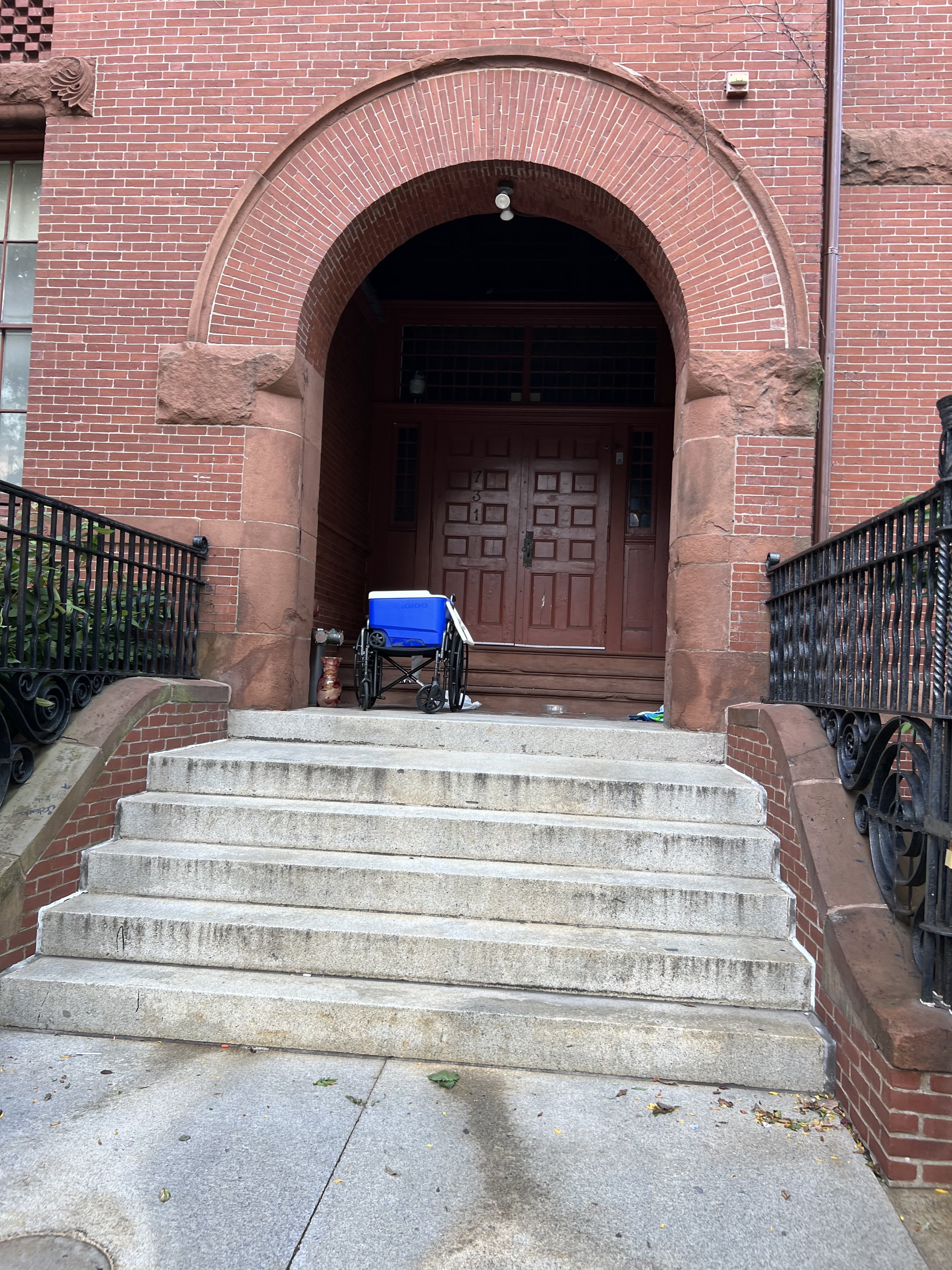Wheelchair and cooler left behind after overnight sleeping in doorway, Harrison Avenue
