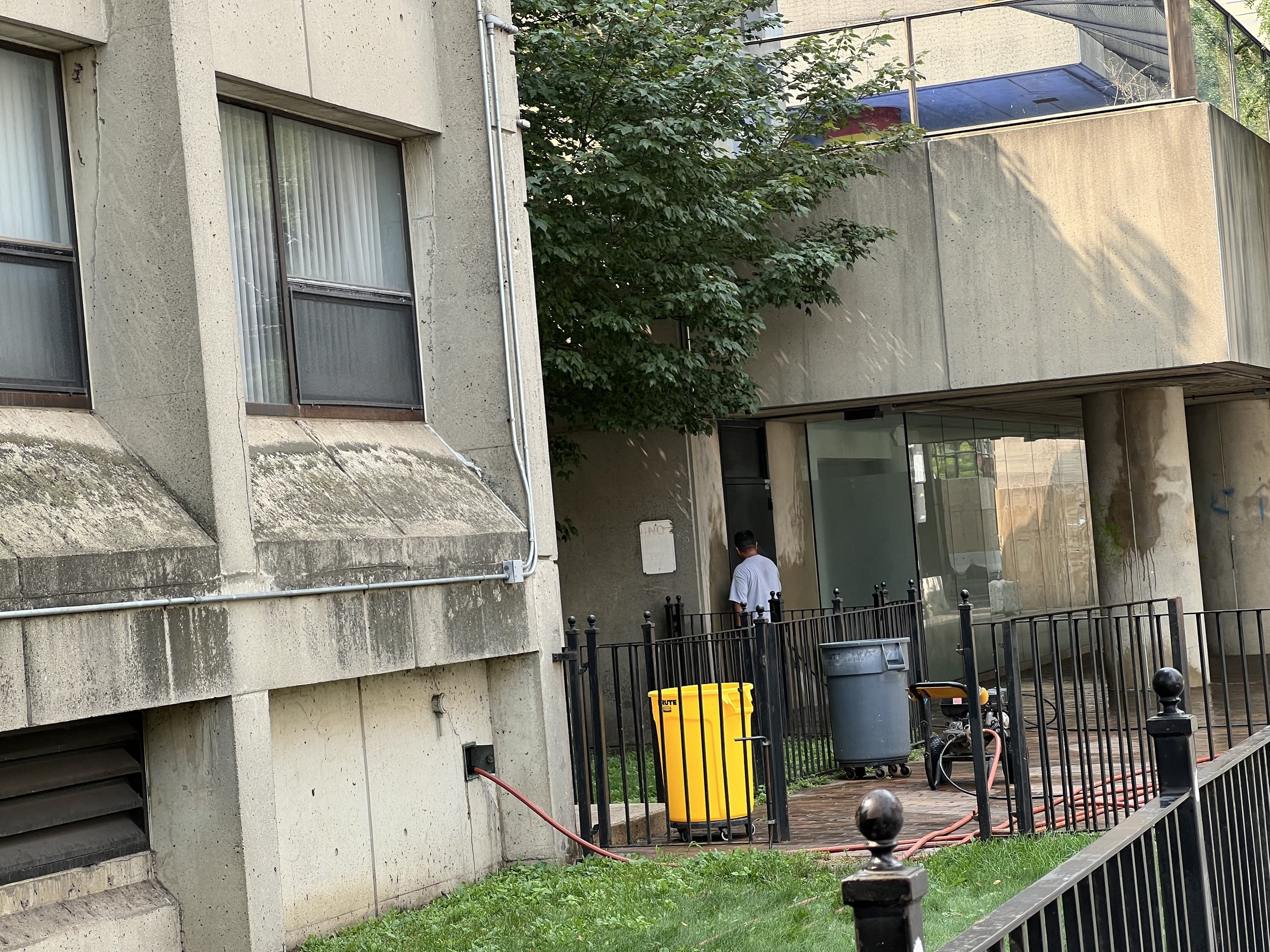 Power washing walls and sidewalk, Mass Ave next to Creamer Building