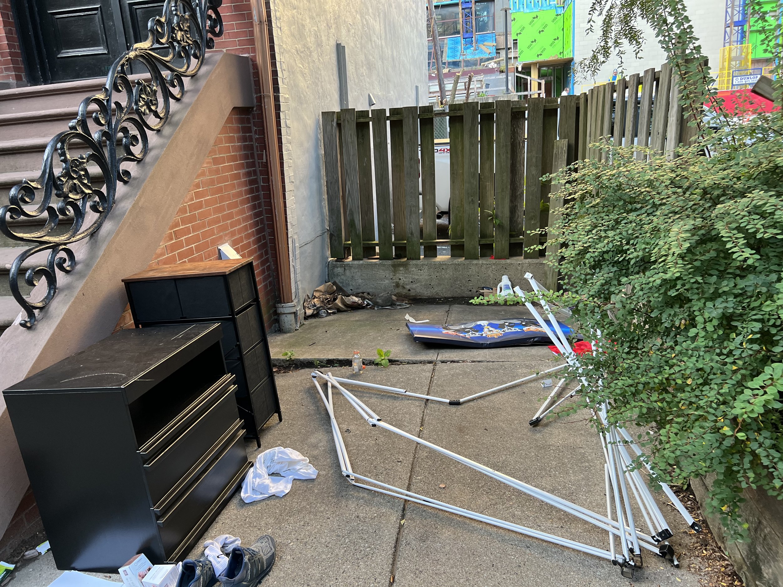 Encampment site next to stoop, East Brookline Street