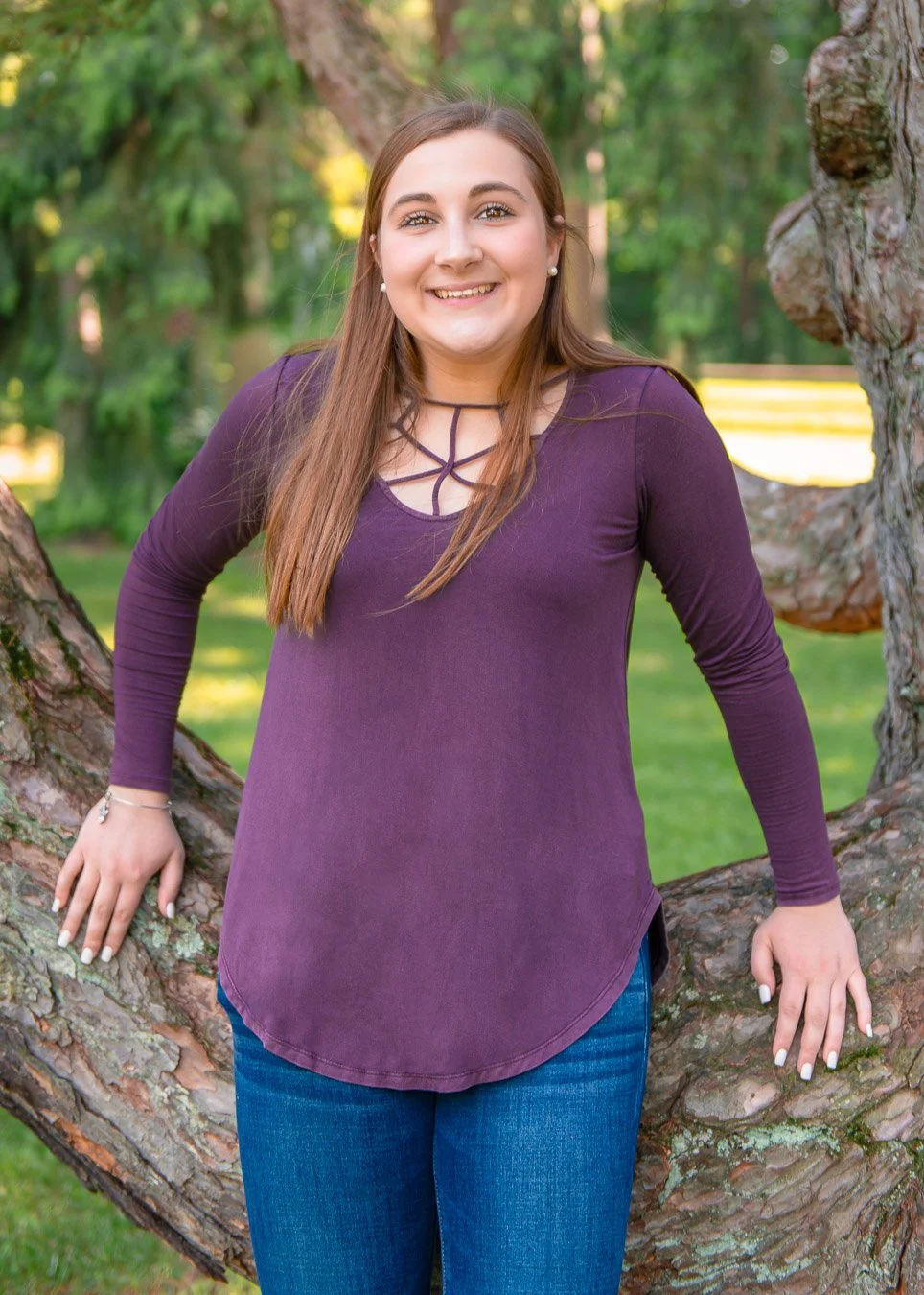 Natalie leaning on tree