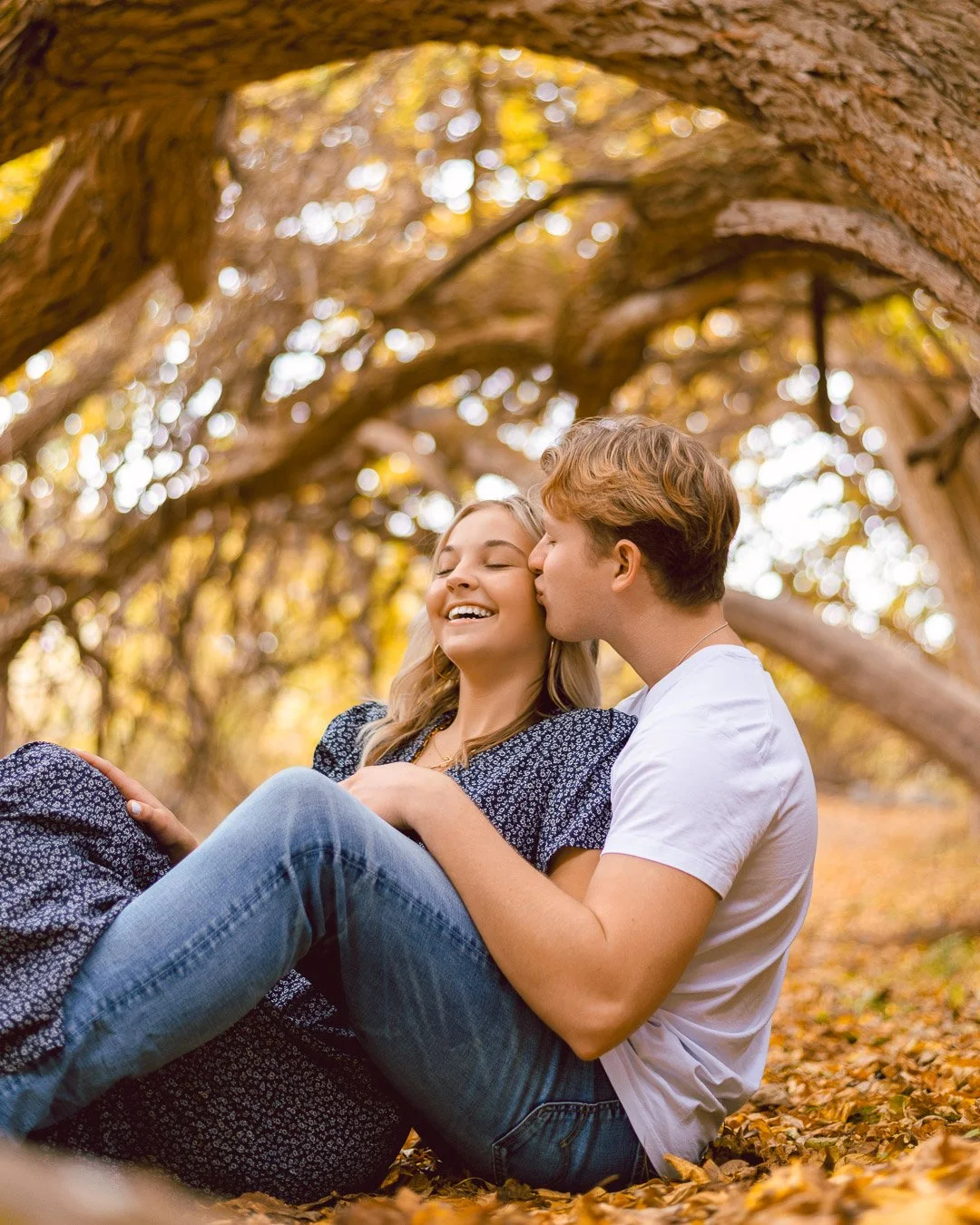 Couple sitting under trees